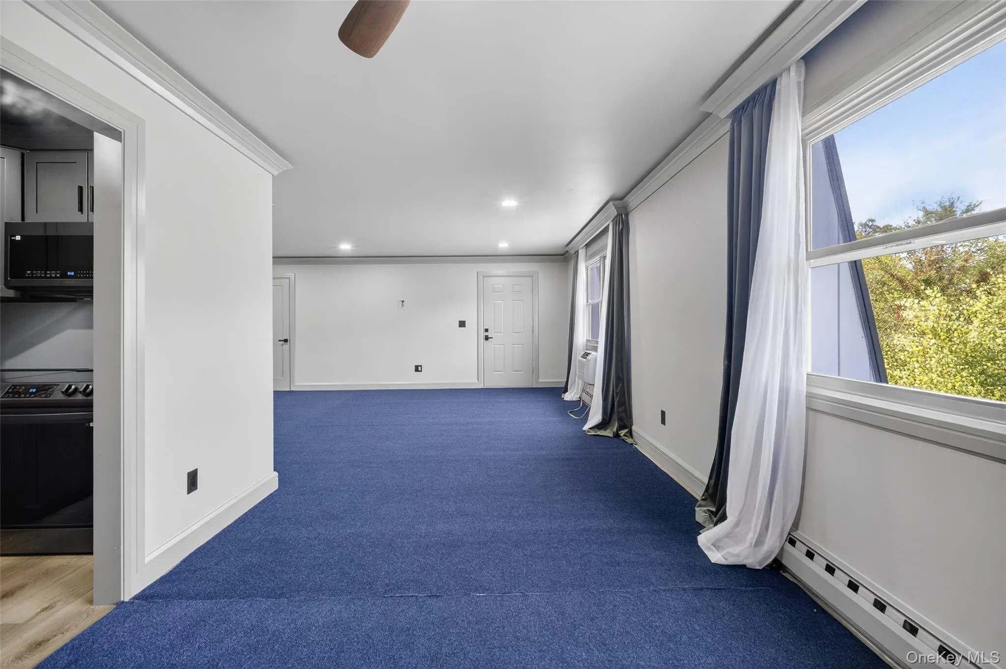 Hall featuring a baseboard radiator, carpet floors, and recessed lighting Hall featuring a baseboard radiator, carpet floors, and recessed lighting