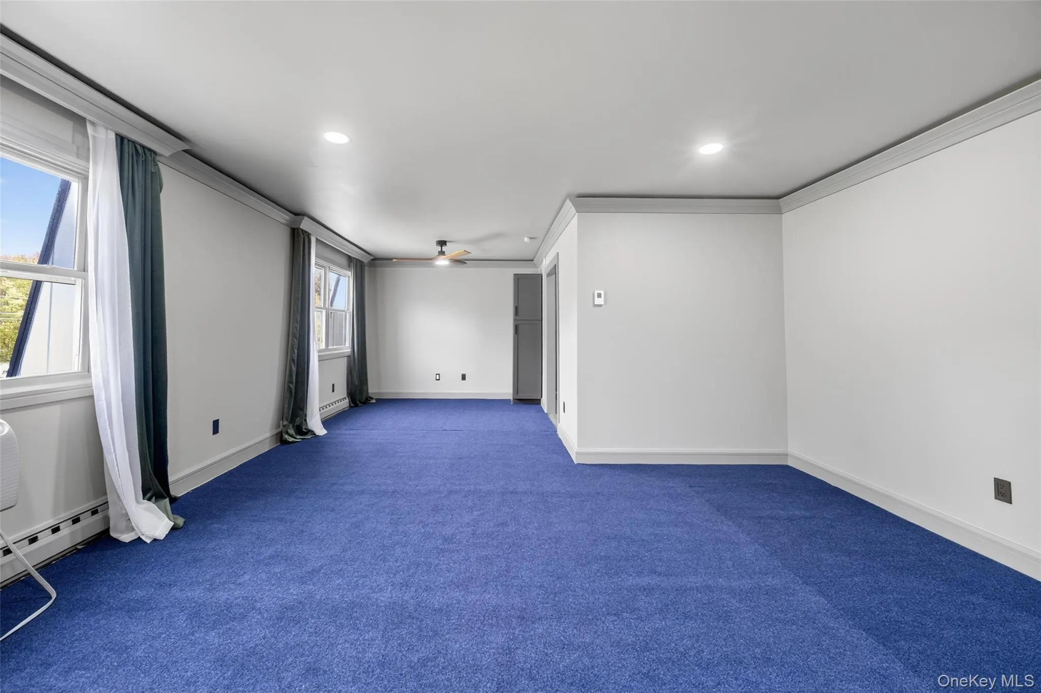 Spare room featuring a ceiling fan, ornamental molding, carpet, and recessed lighting Spare room featuring a ceiling fan, ornamental molding, carpet, and recessed lighting