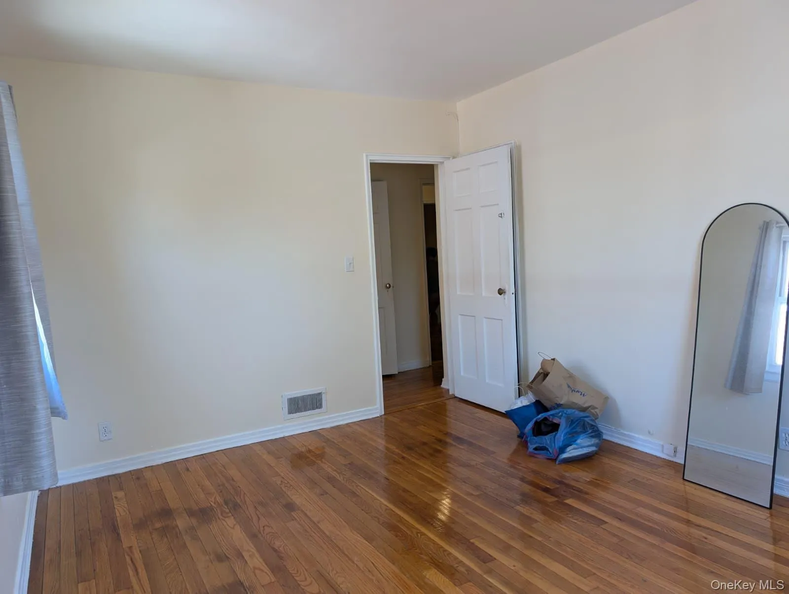 Unfurnished bedroom featuring wood finished floors and baseboards Unfurnished bedroom featuring wood finished floors and baseboards