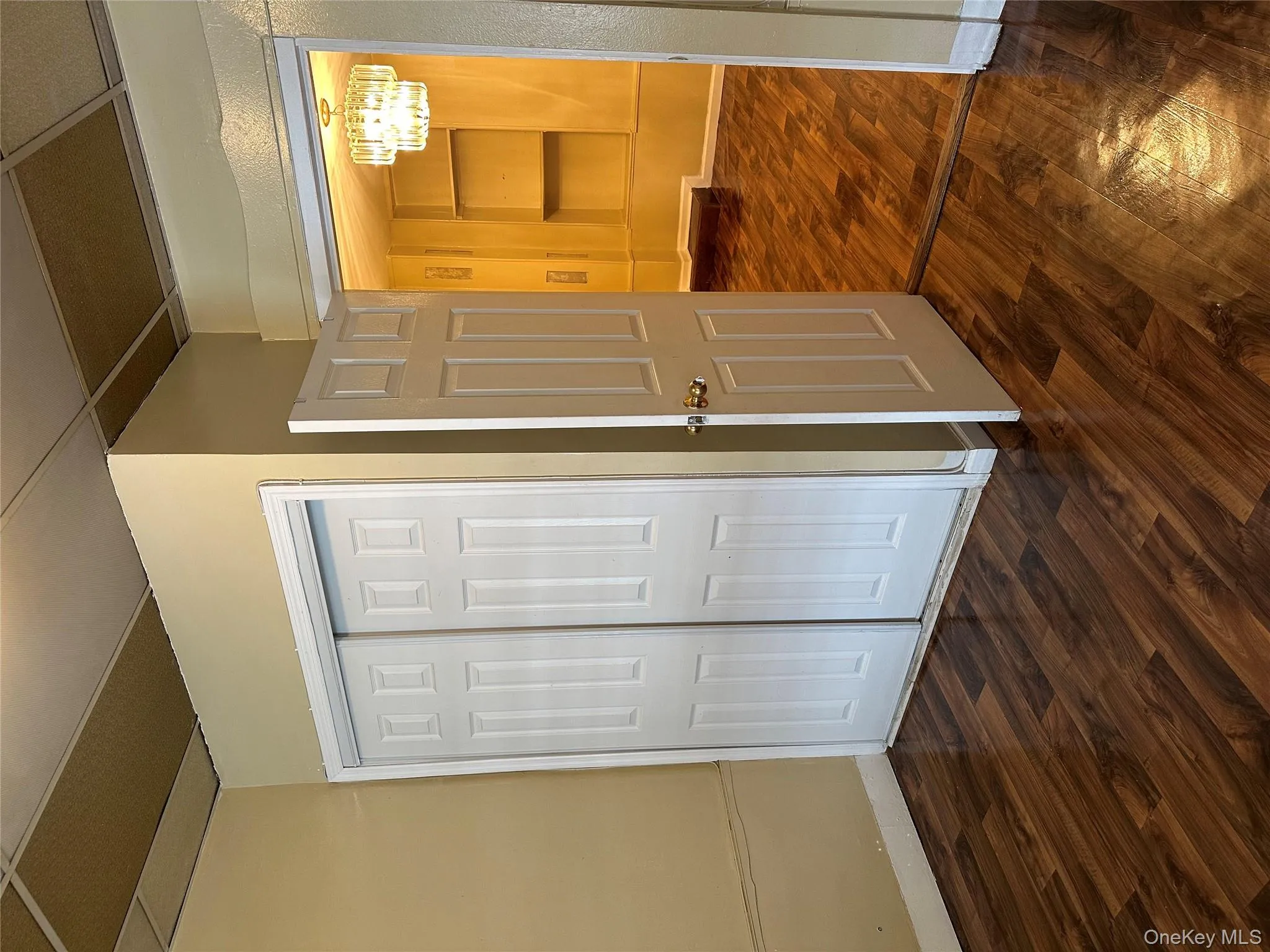 Larger bedroom featuring a double closet, dark wood-type flooring, and a chandelier Larger bedroom featuring a double closet, dark wood-type flooring, and a chandelier