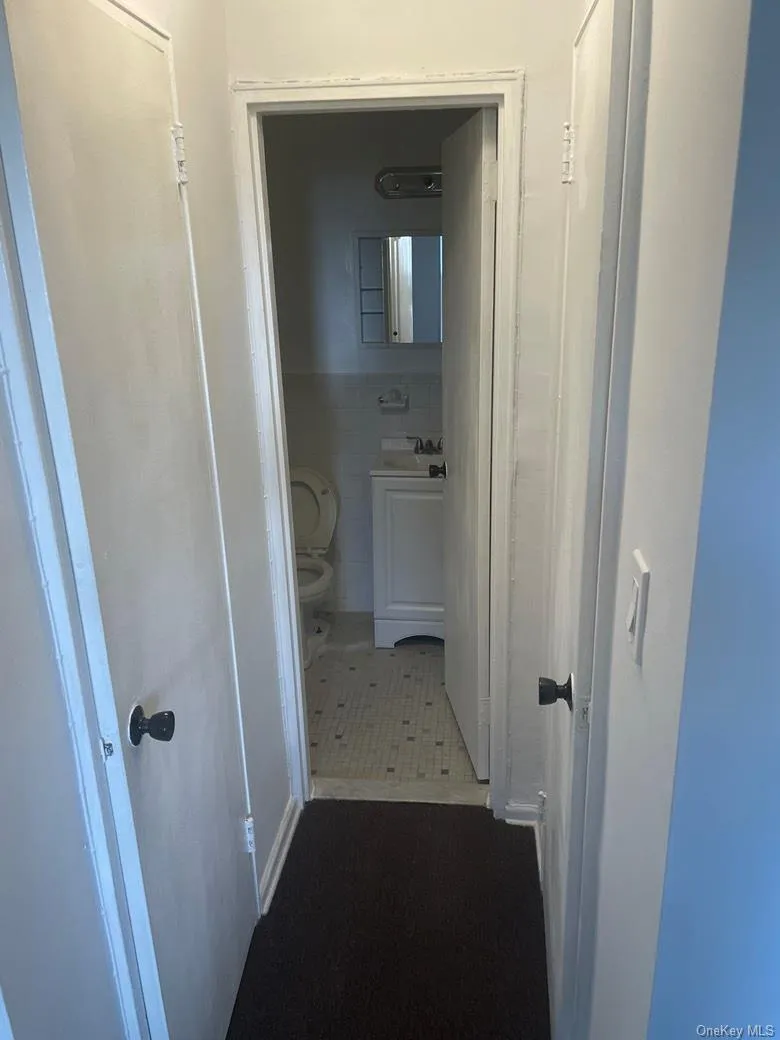 Hall featuring tile walls Hall featuring tile walls