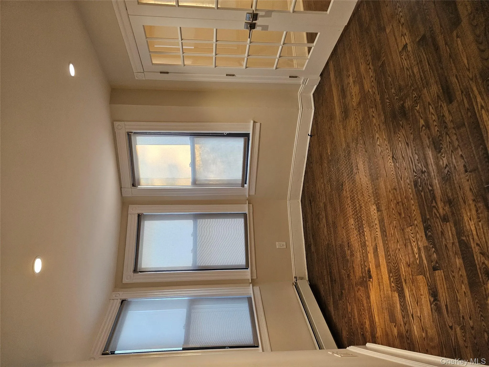Spare room featuring dark wood-style floors, recessed lighting, a baseboard heating unit, and french doors Spare room featuring dark wood-style floors, recessed lighting, a baseboard heating unit, and french doors