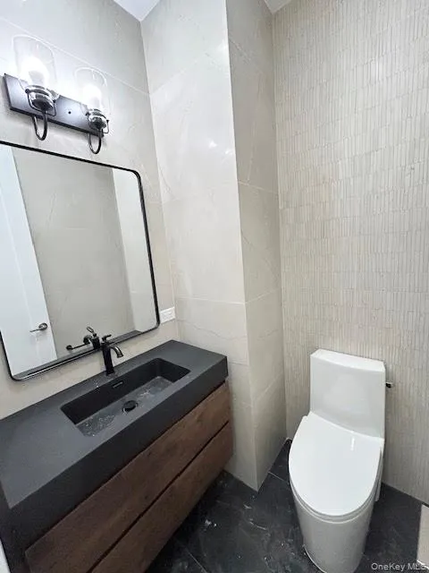 Bathroom with tile walls and vanity Bathroom with tile walls and vanity