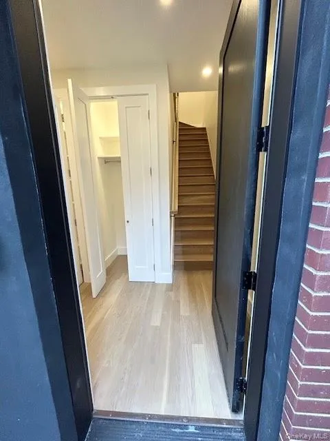 Hallway with light wood finished floors and stairs Hallway with light wood finished floors and stairs
