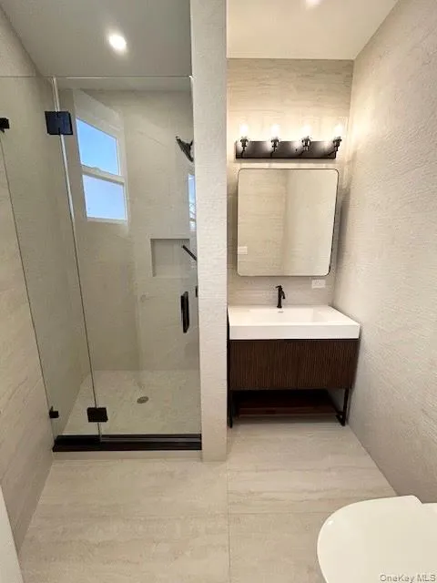 Full bath featuring a shower stall, vanity, and recessed lighting Full bath featuring a shower stall, vanity, and recessed lighting