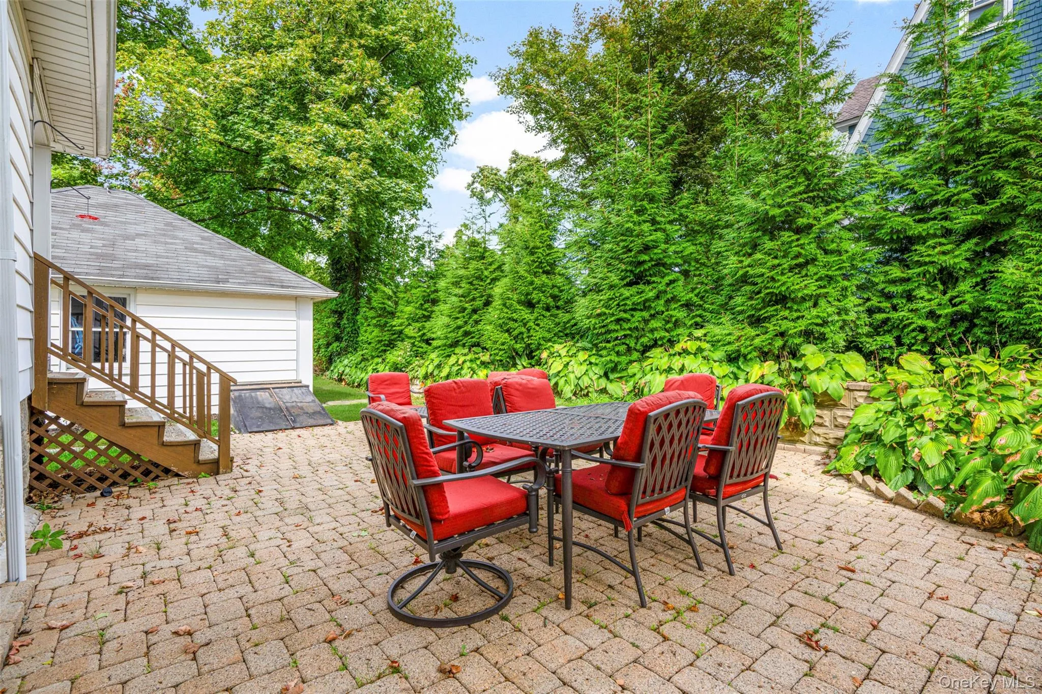 View of patio with outdoor dining area and view of scattered trees View of patio with outdoor dining area and view of scattered trees