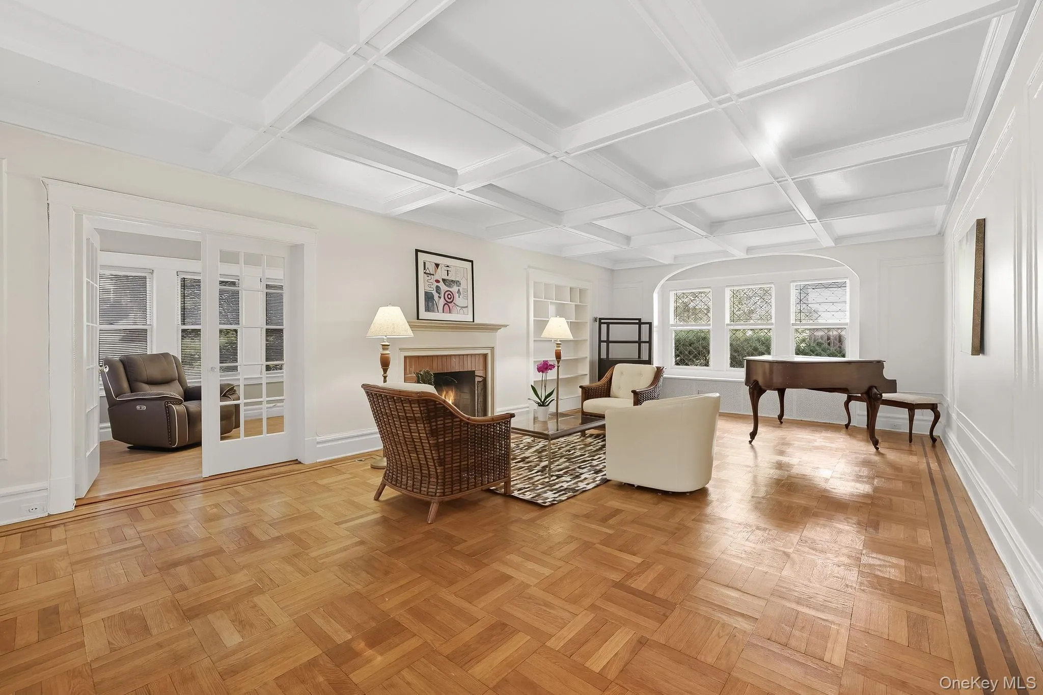 Large living room with coffered ceiling brick fireplace and stained glass windows Large living room with coffered ceiling brick fireplace and stained glass windows