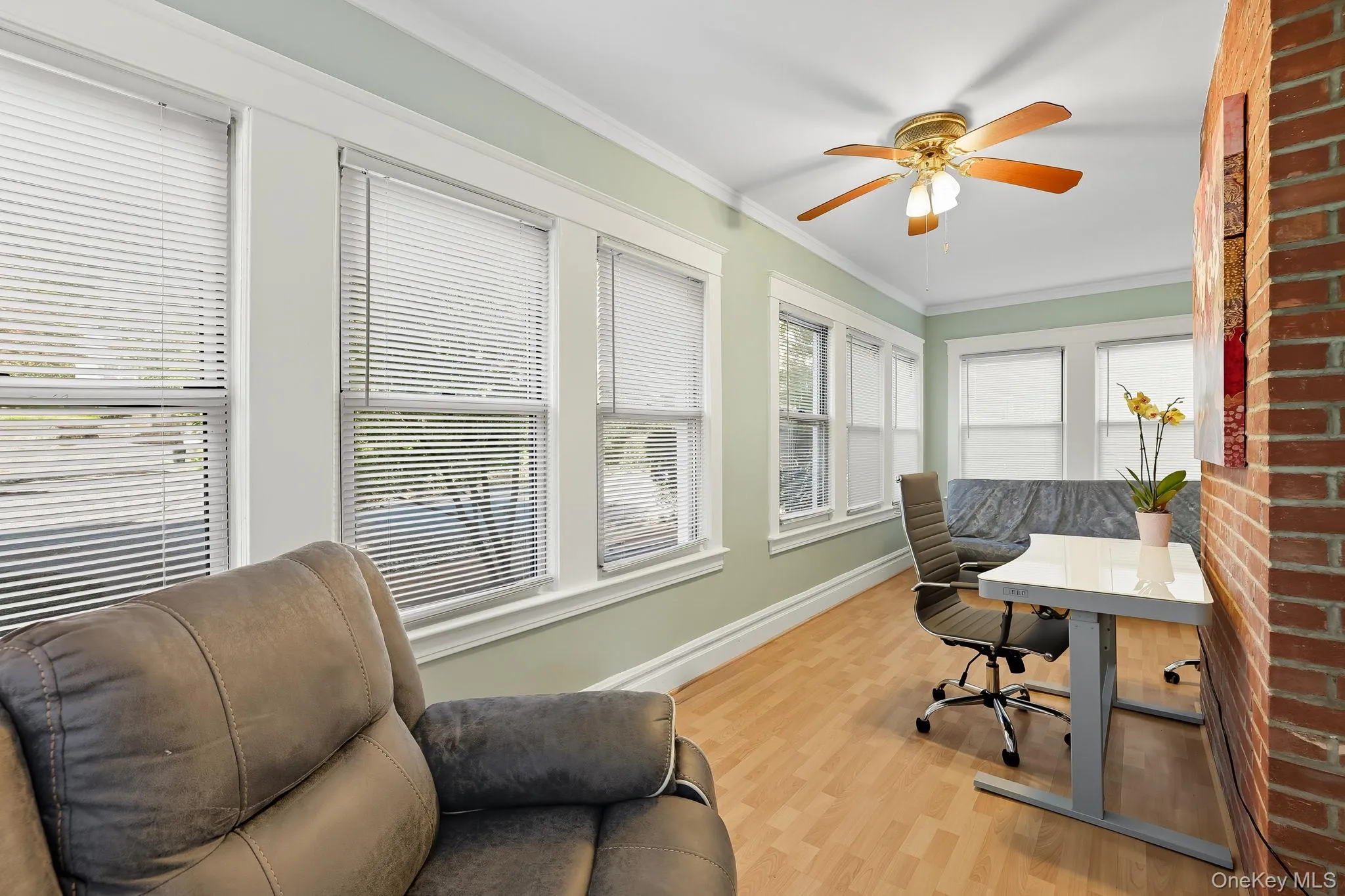 Office area featuring crown molding, light wood-style floors, and a ceiling fan Office area featuring crown molding, light wood-style floors, and a ceiling fan