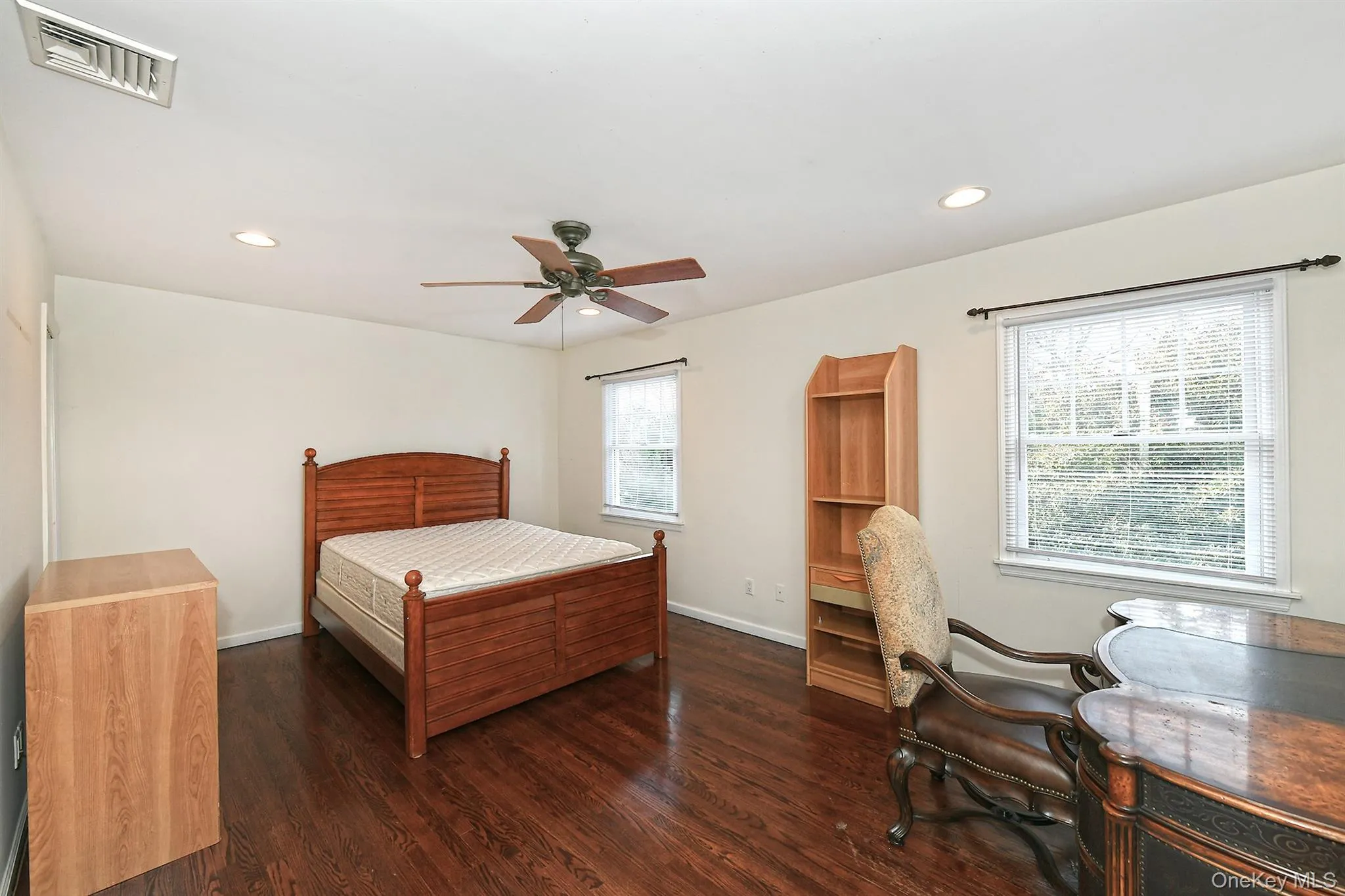 Bedroom featuring dark wood finished floors, recessed lighting, and a ceiling fan Bedroom featuring dark wood finished floors, recessed lighting, and a ceiling fan