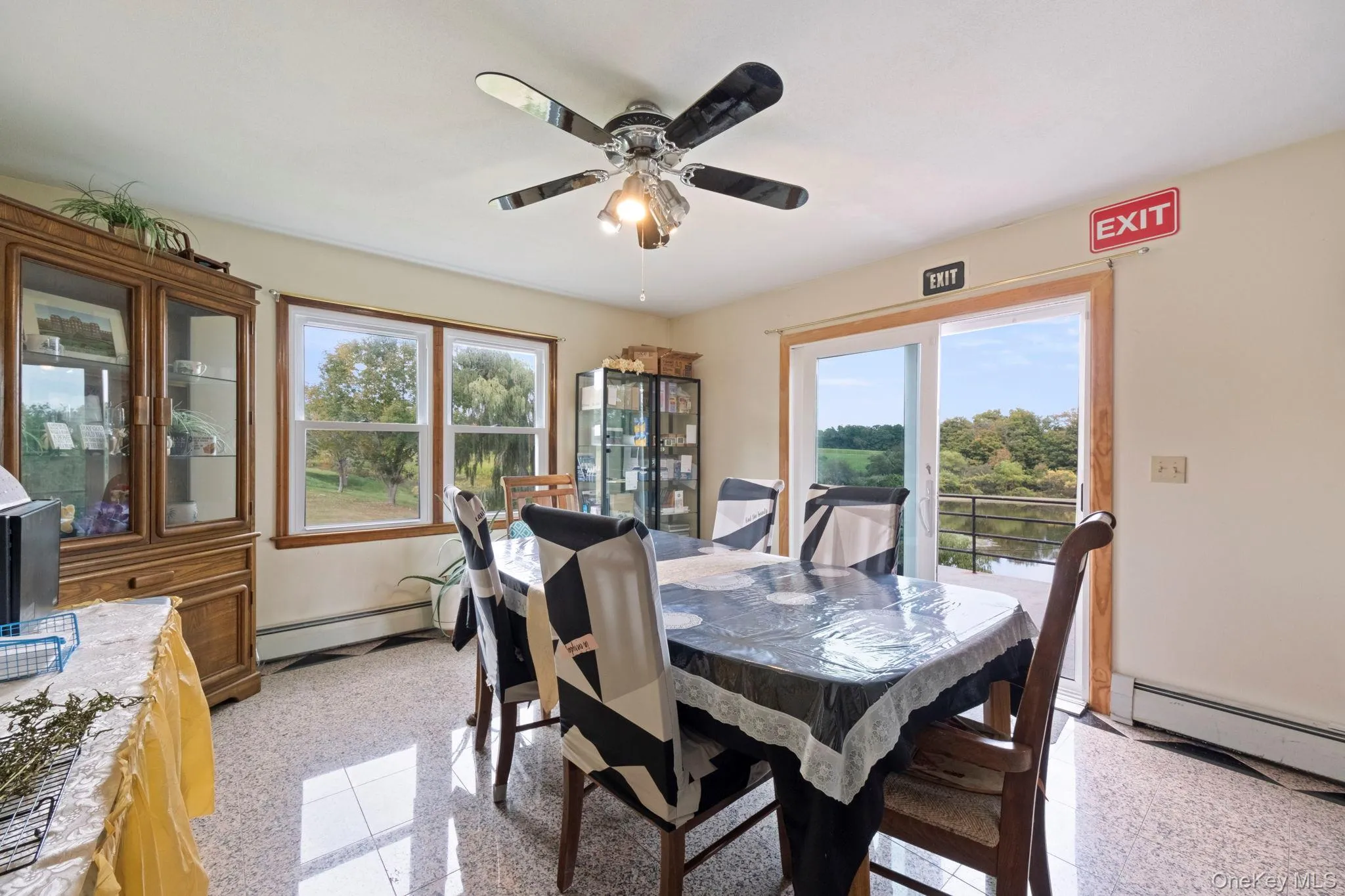 Dining space featuring plenty of natural light, baseboard heating, and granite floors Dining space featuring plenty of natural light, baseboard heating, and granite floors