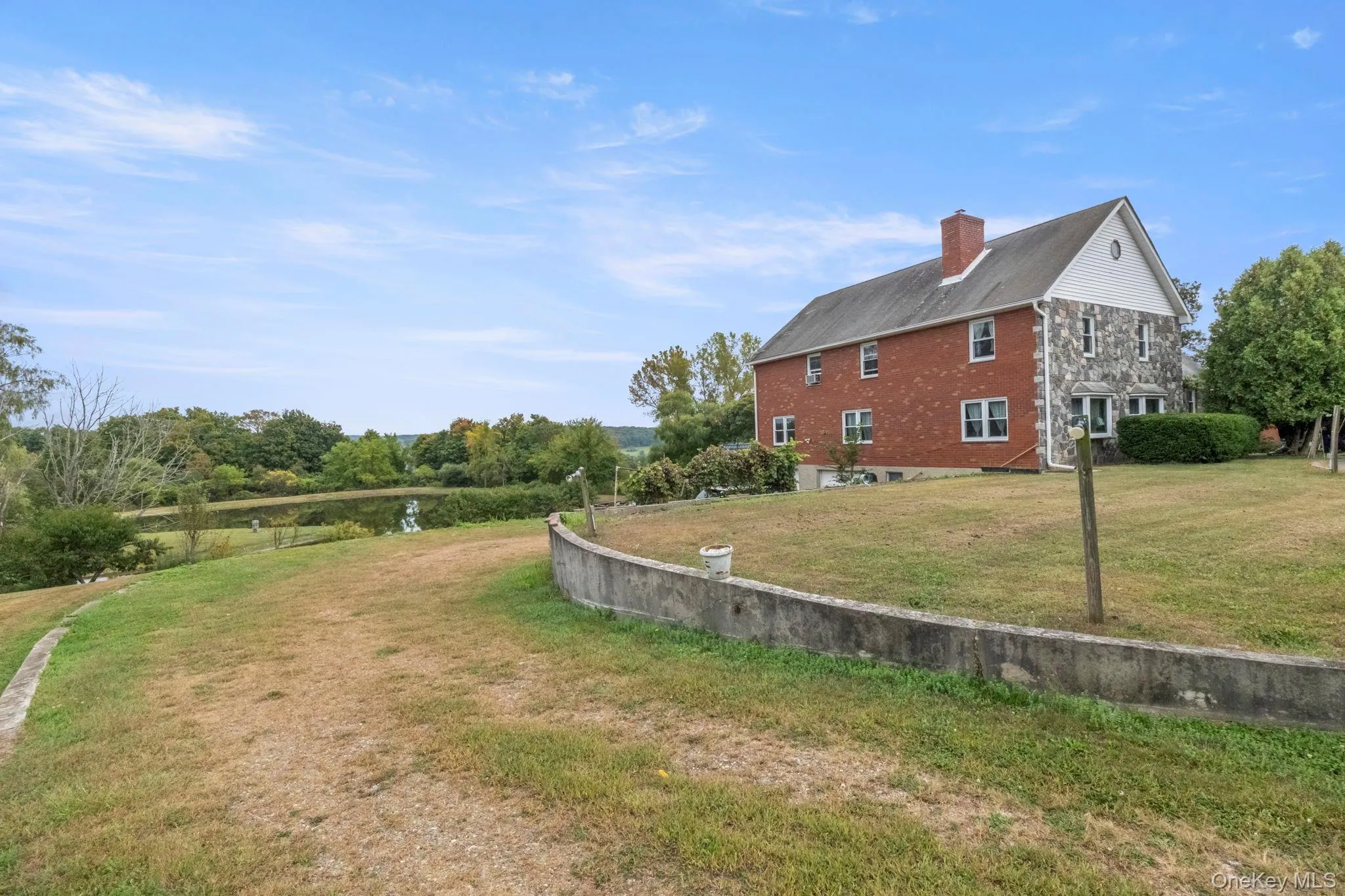 View of property exterior with a yard and a chimney View of property exterior with a yard and a chimney