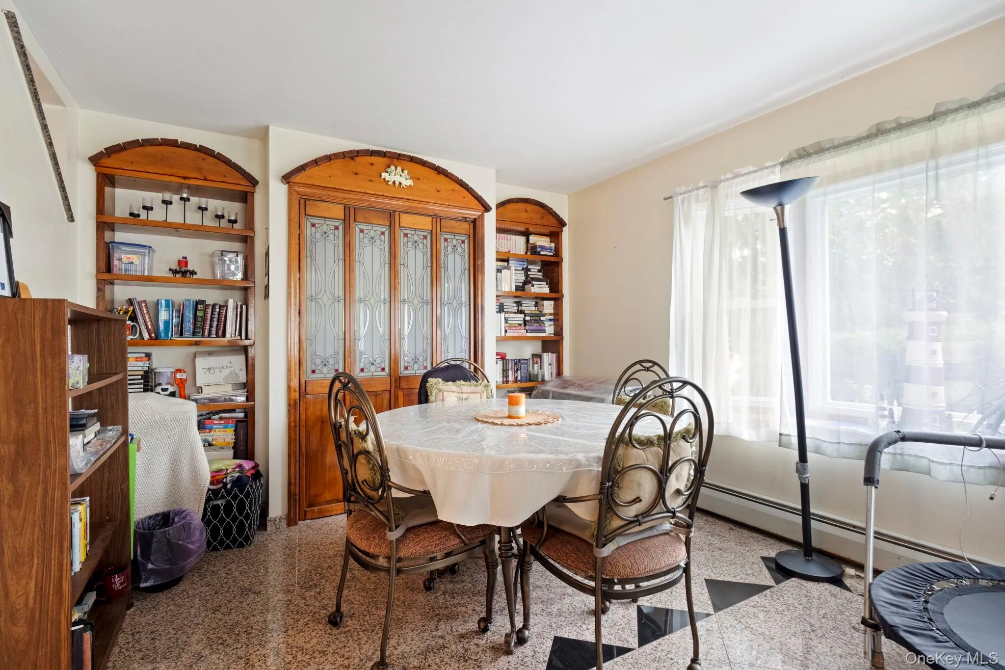 Dining space with french doors and a baseboard radiator Dining space with french doors and a baseboard radiator