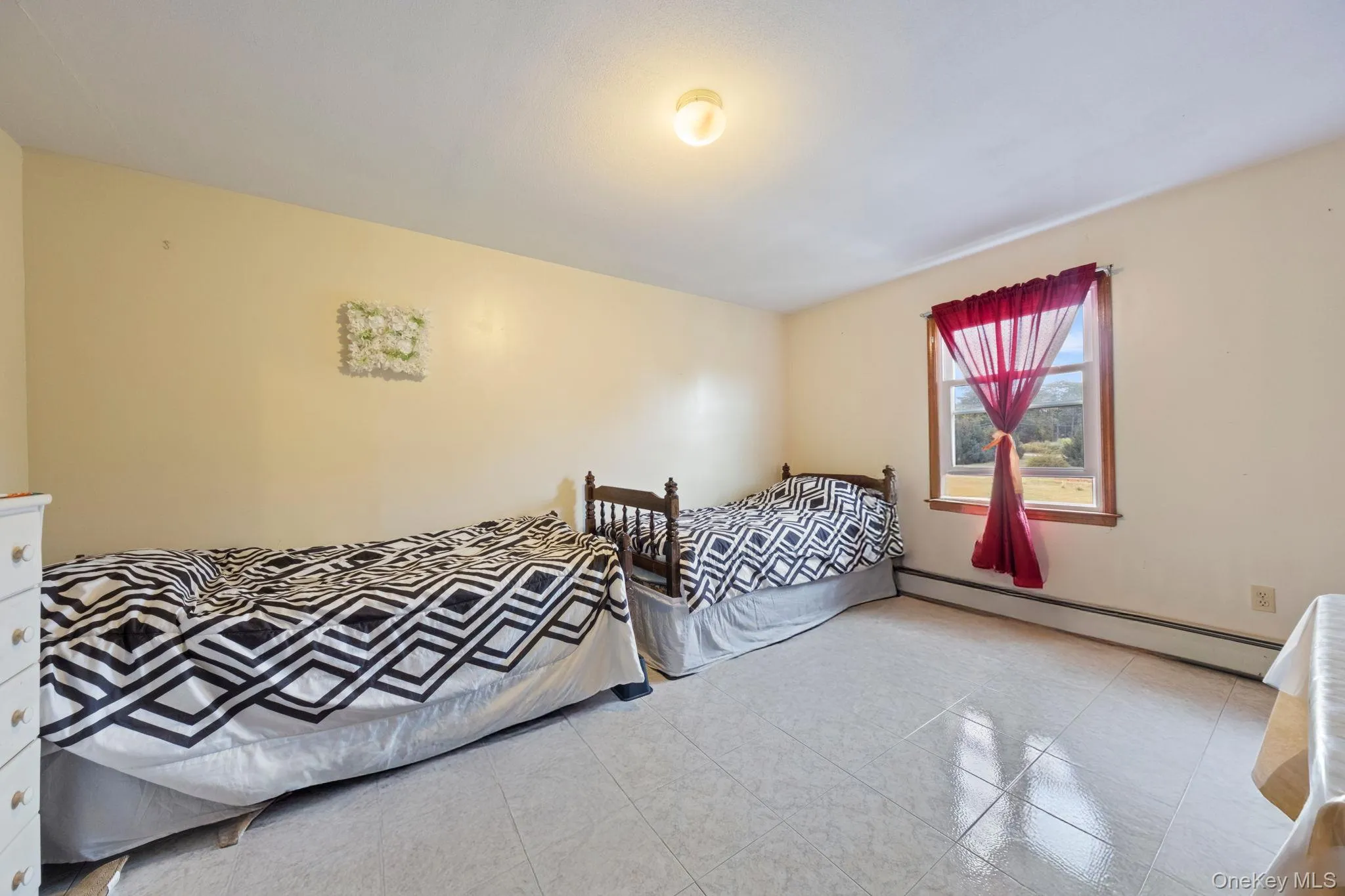 Tiled bedroom with baseboard heating Tiled bedroom with baseboard heating