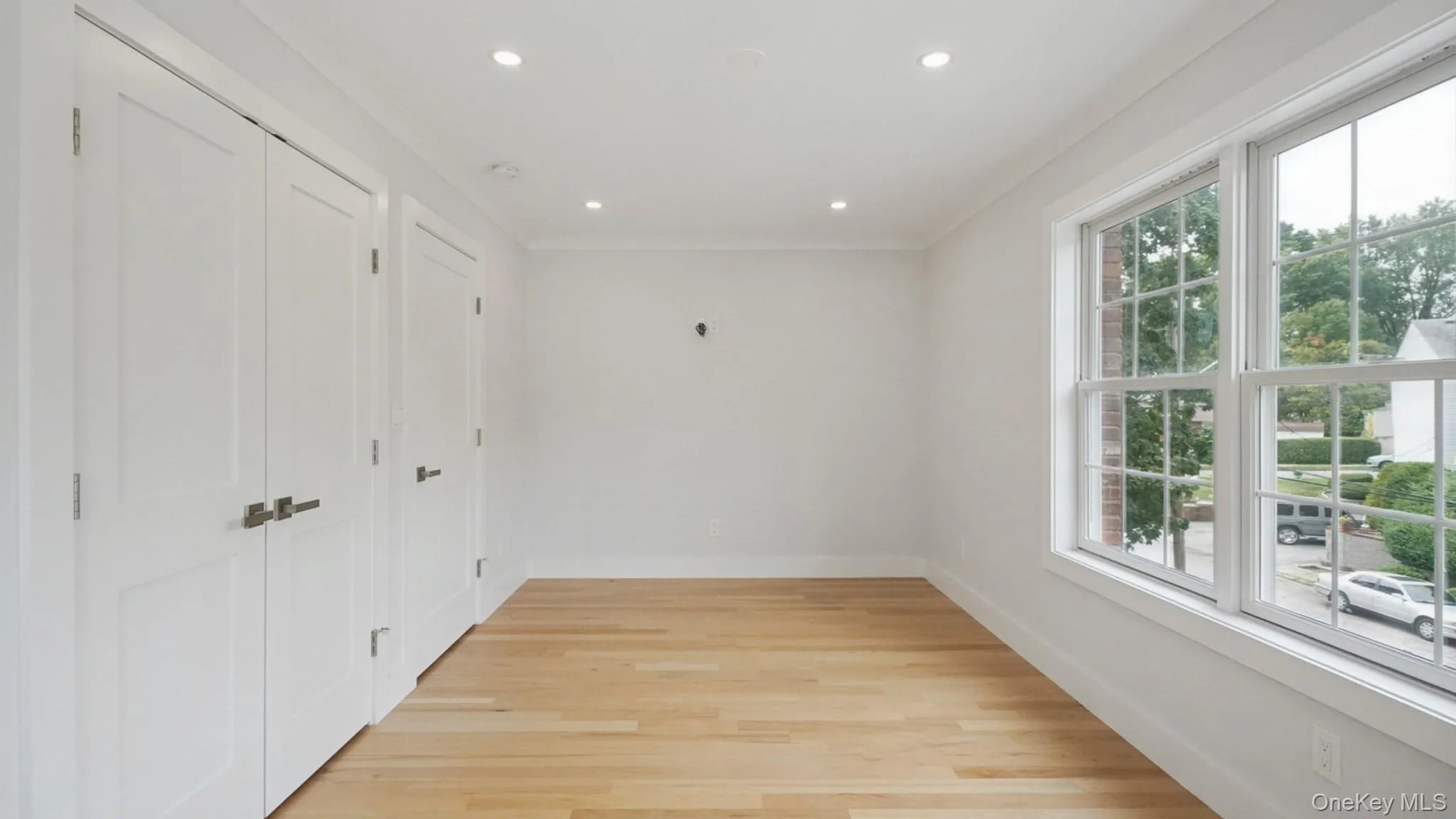 Unfurnished room featuring light wood-style floors and recessed lighting Unfurnished room featuring light wood-style floors and recessed lighting