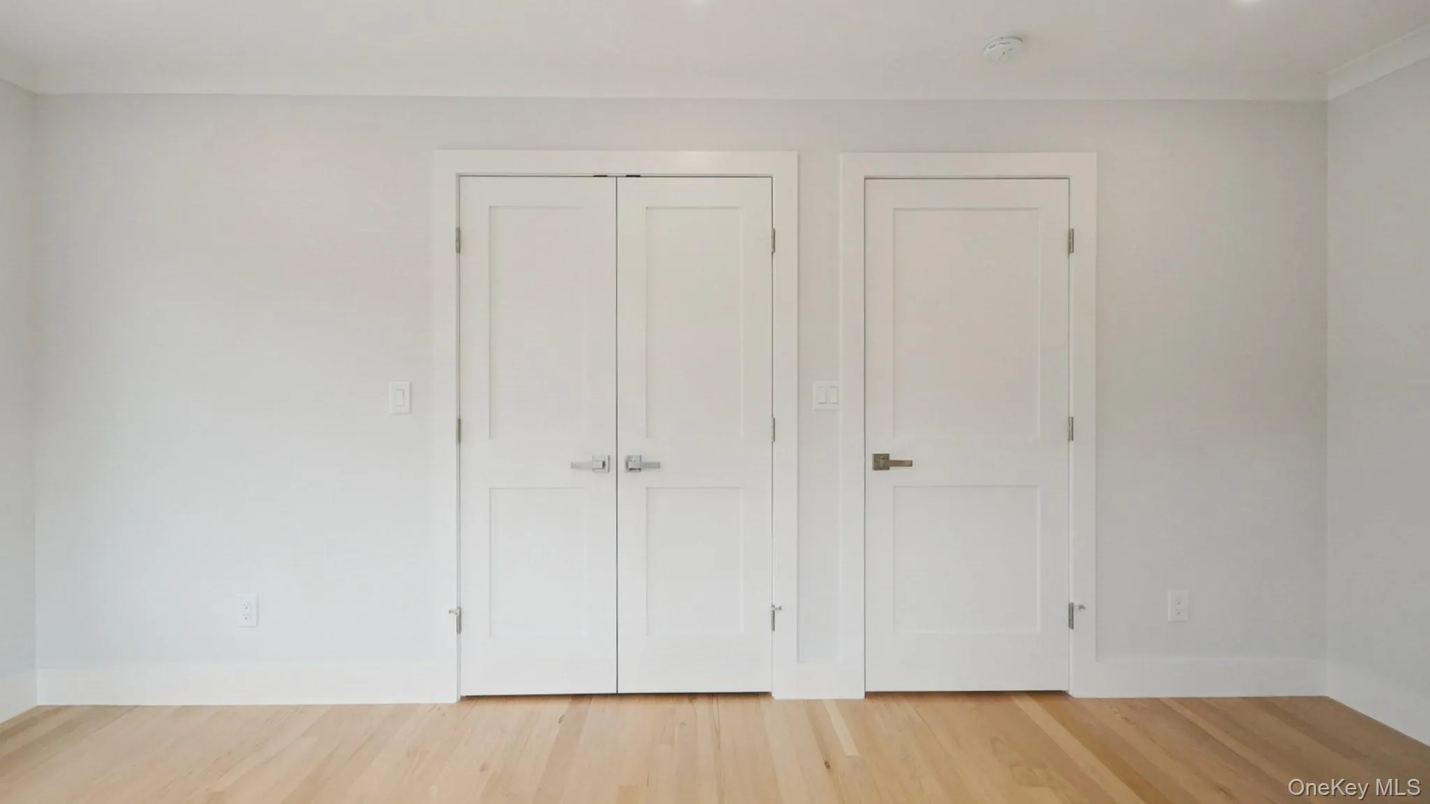 Unfurnished bedroom with wood finished floors and a closet Unfurnished bedroom with wood finished floors and a closet