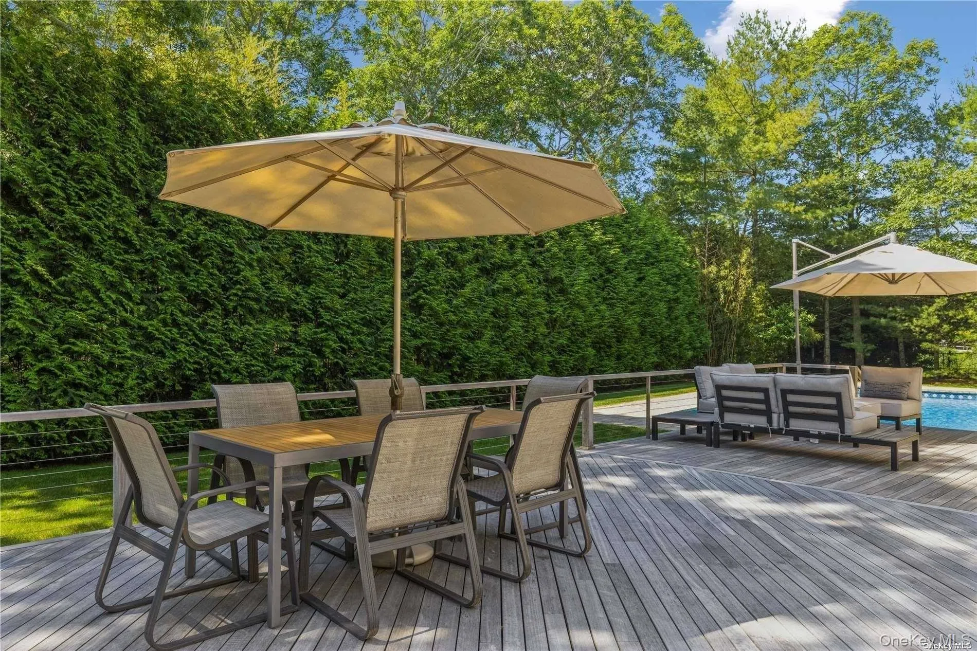 Wooden deck with outdoor dining area and an outdoor living space Wooden deck with outdoor dining area and an outdoor living space