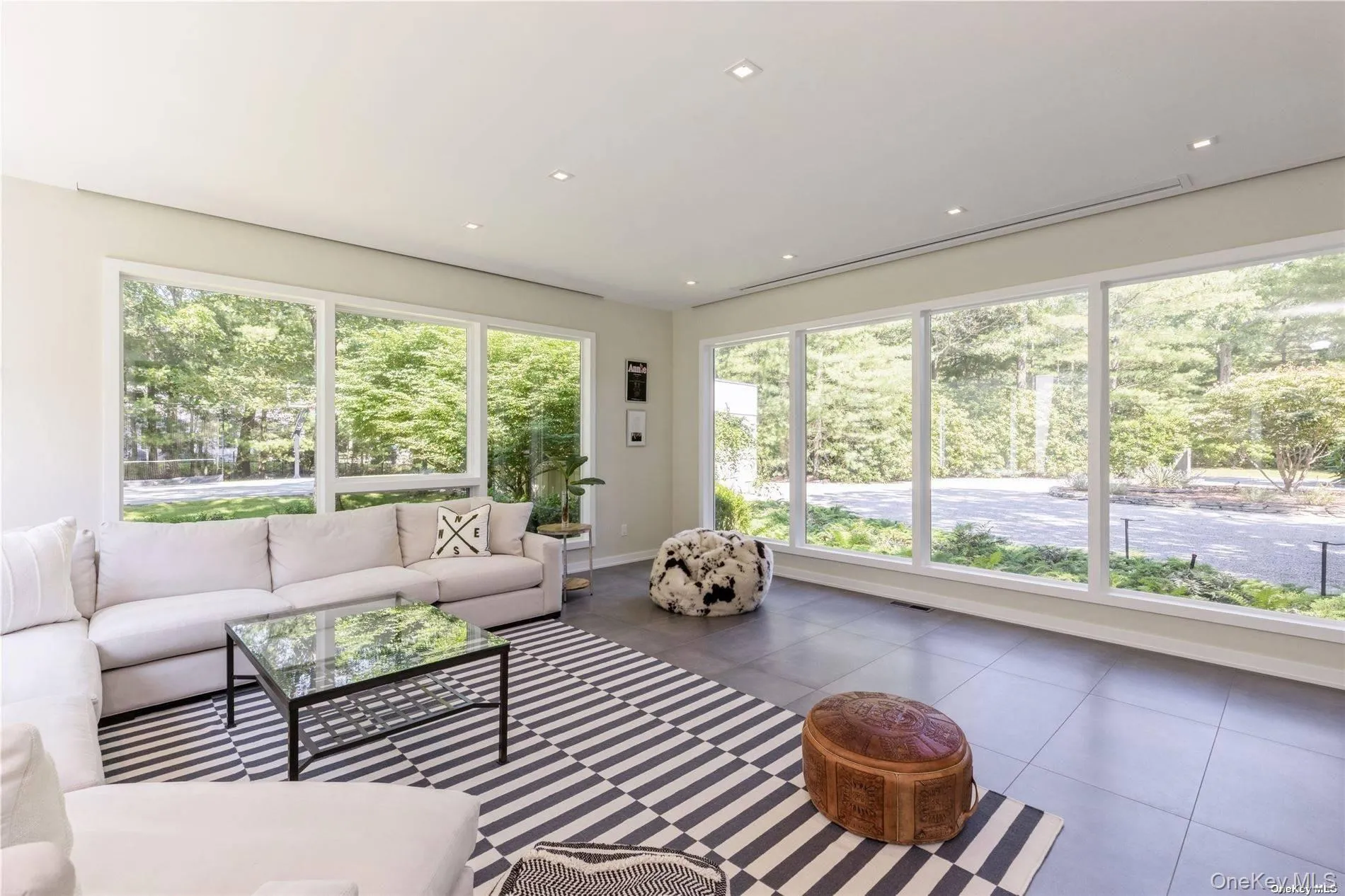 Tiled living area with recessed lighting and baseboards Tiled living area with recessed lighting and baseboards