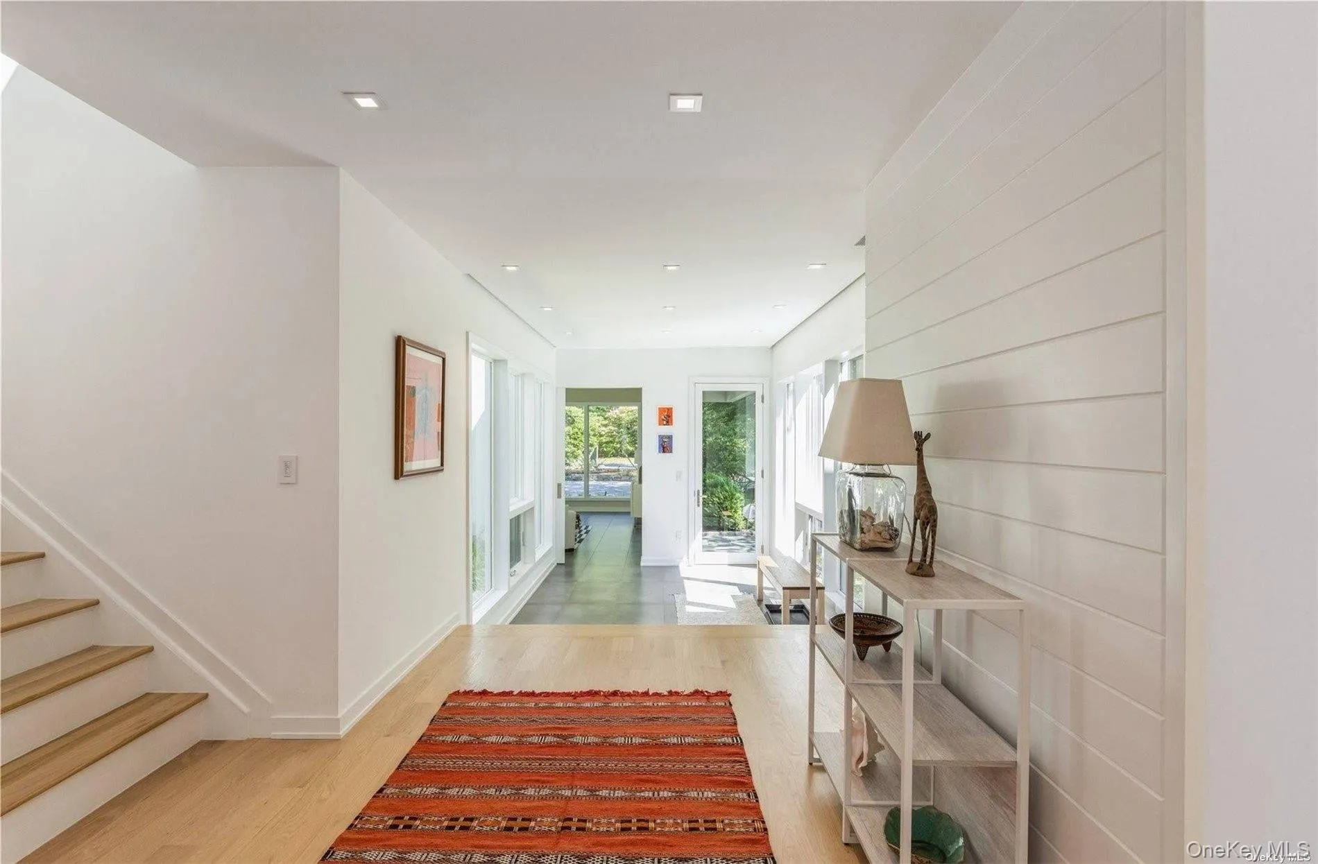Hallway featuring stairway, light wood-style floors, and recessed lighting Hallway featuring stairway, light wood-style floors, and recessed lighting