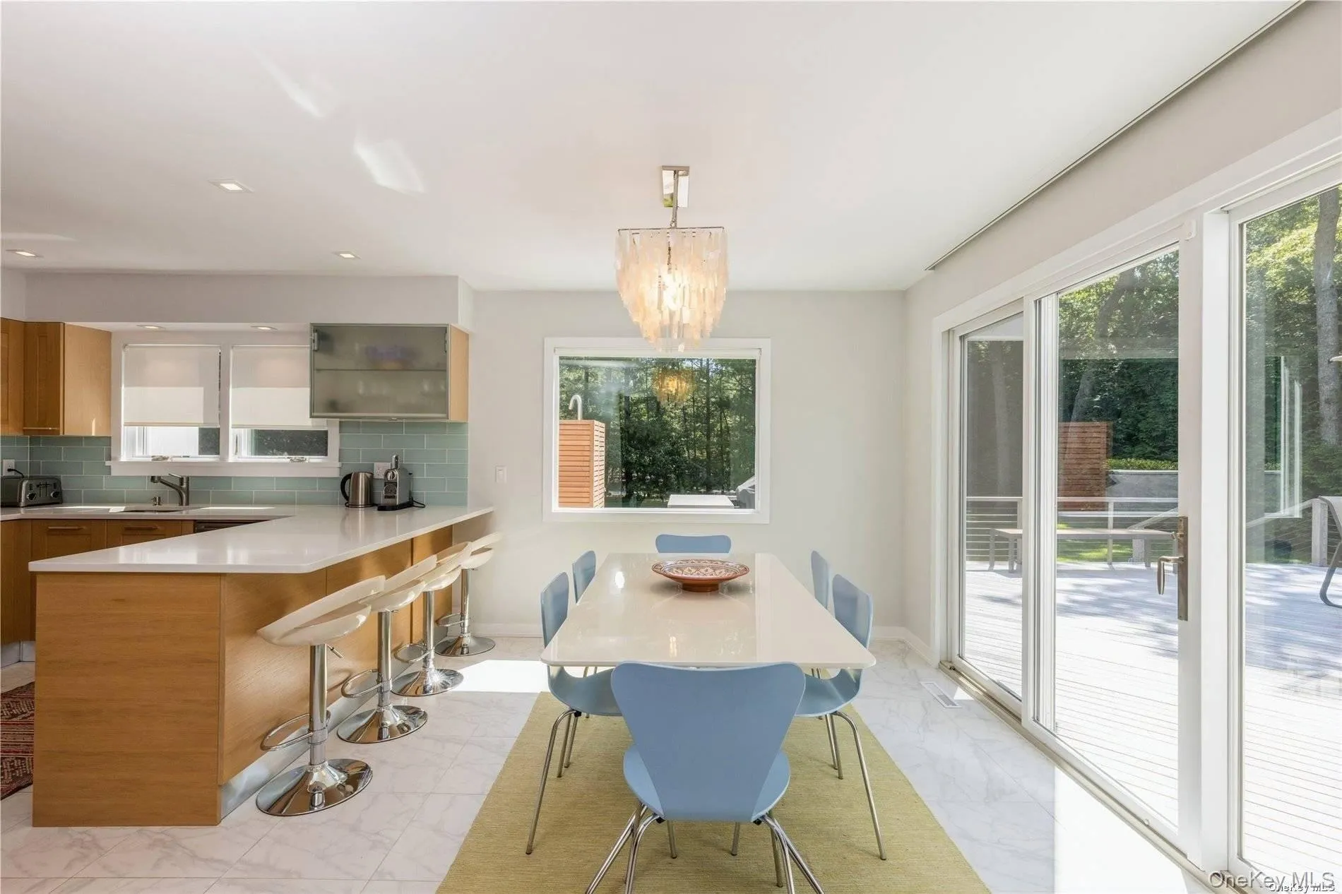 Dining room featuring light marble finish floors, recessed lighting, and a chandelier Dining room featuring light marble finish floors, recessed lighting, and a chandelier