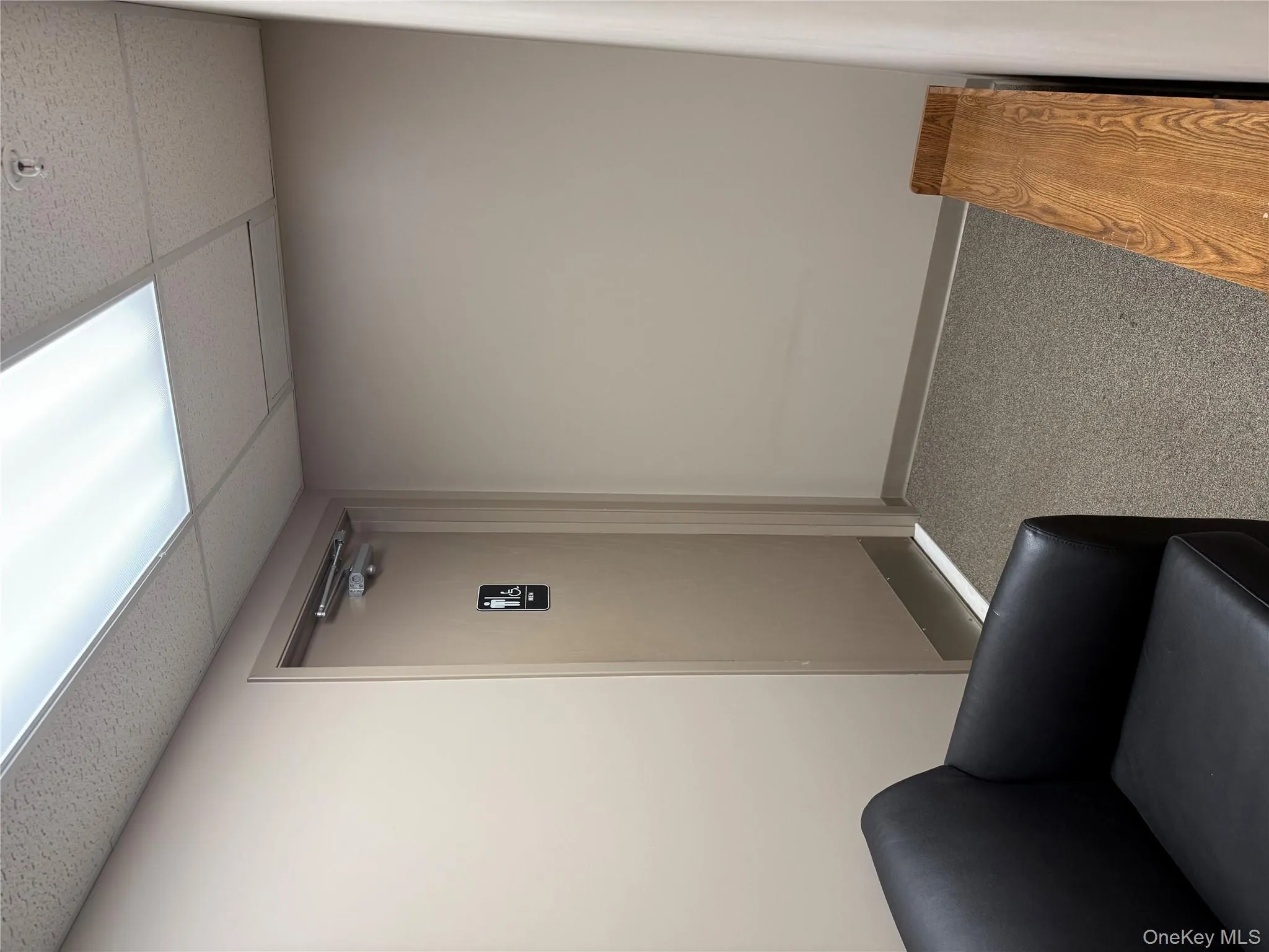 Sitting room with a drop ceiling and carpet Sitting room with a drop ceiling and carpet