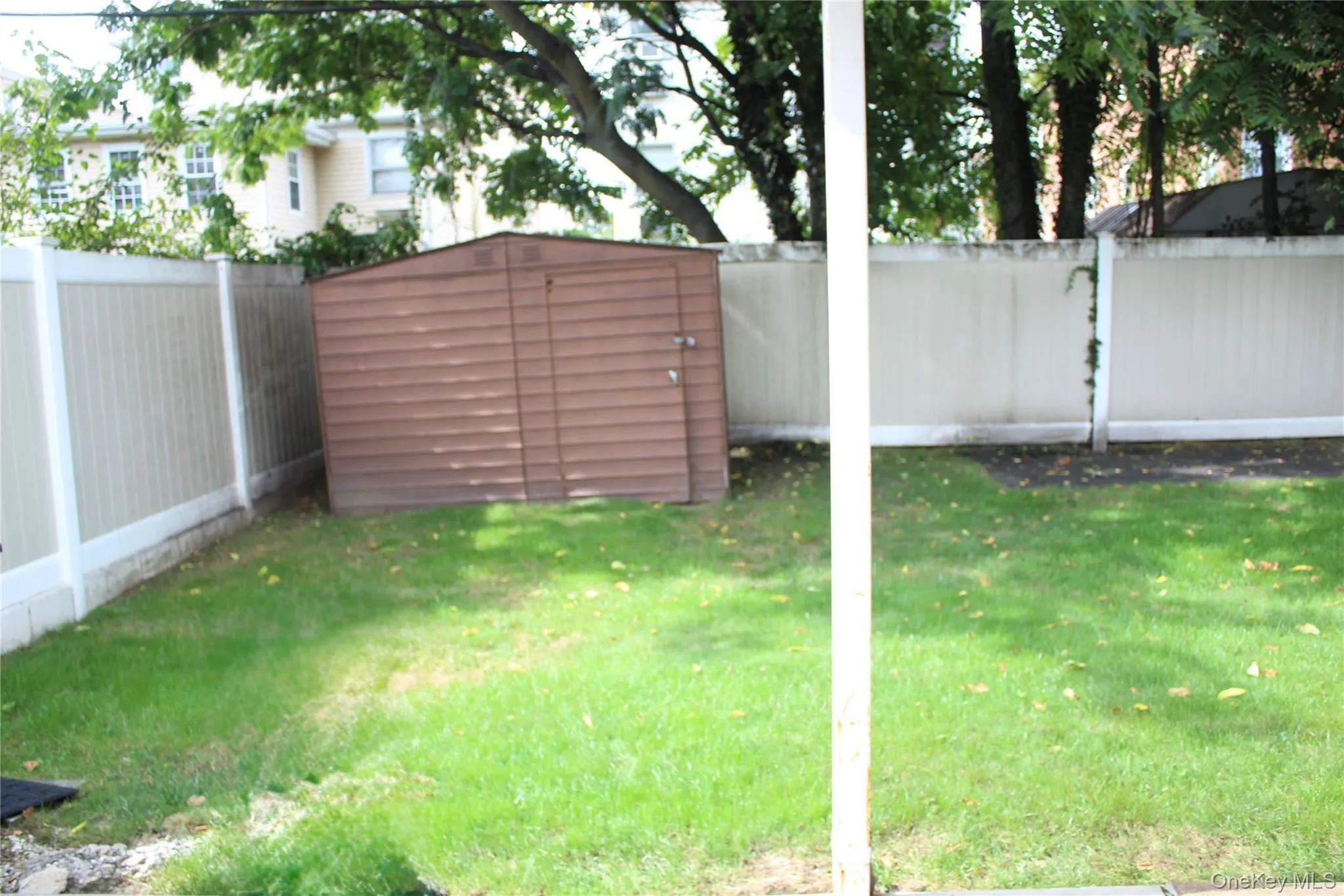 Fenced backyard with a shed Fenced backyard with a shed