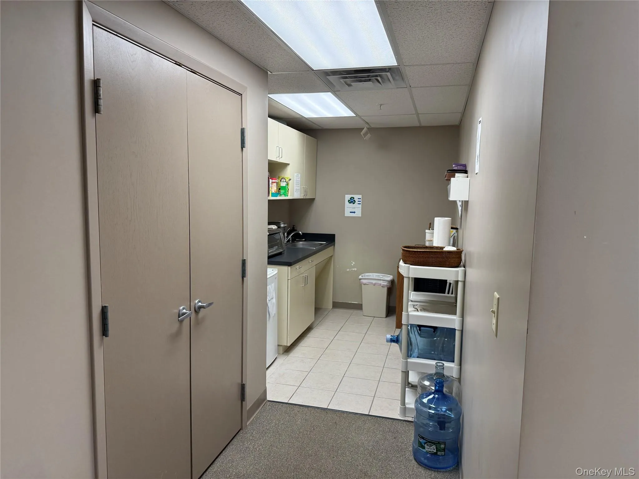 Washroom featuring light tile patterned floors and light colored carpet Washroom featuring light tile patterned floors and light colored carpet