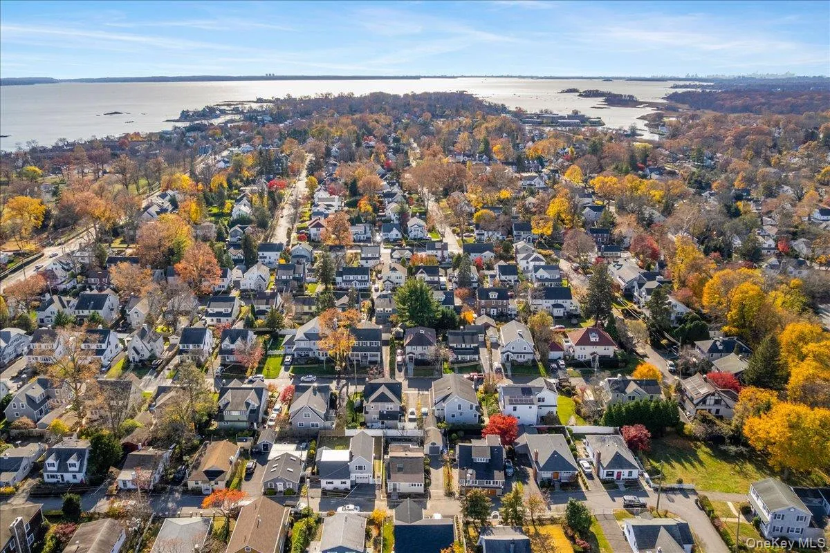 Aerial overview of property's location featuring nearby suburban area and a nearby body of water Aerial overview of property's location featuring nearby suburban area and a nearby body of water