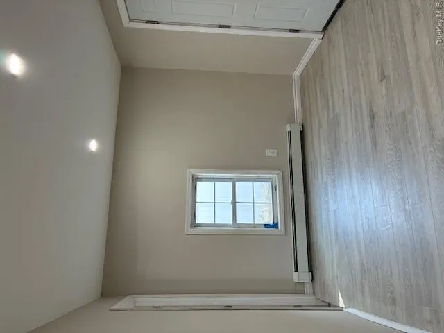 Unfurnished room with light wood-style floors, baseboard heating, and recessed lighting Unfurnished room with light wood-style floors, baseboard heating, and recessed lighting
