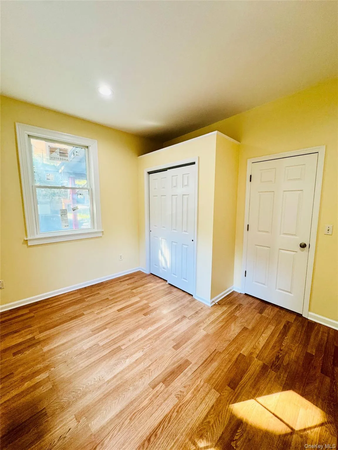 Unfurnished bedroom with light wood-style floors and a closet Unfurnished bedroom with light wood-style floors and a closet