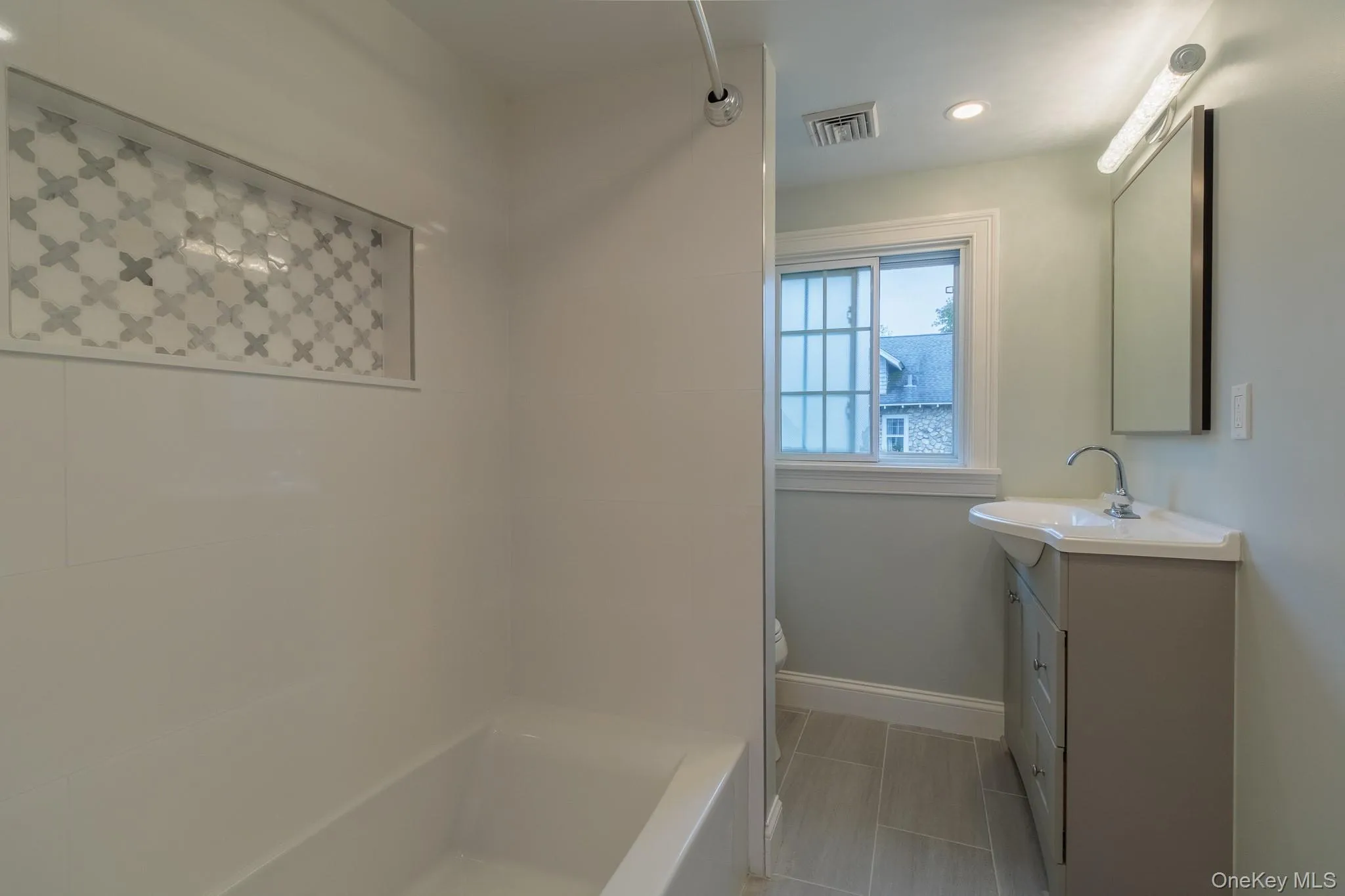 Full bath featuring vanity, recessed lighting, light tile patterned floors, and shower / bath combination Full bath featuring vanity, recessed lighting, light tile patterned floors, and shower / bath combination