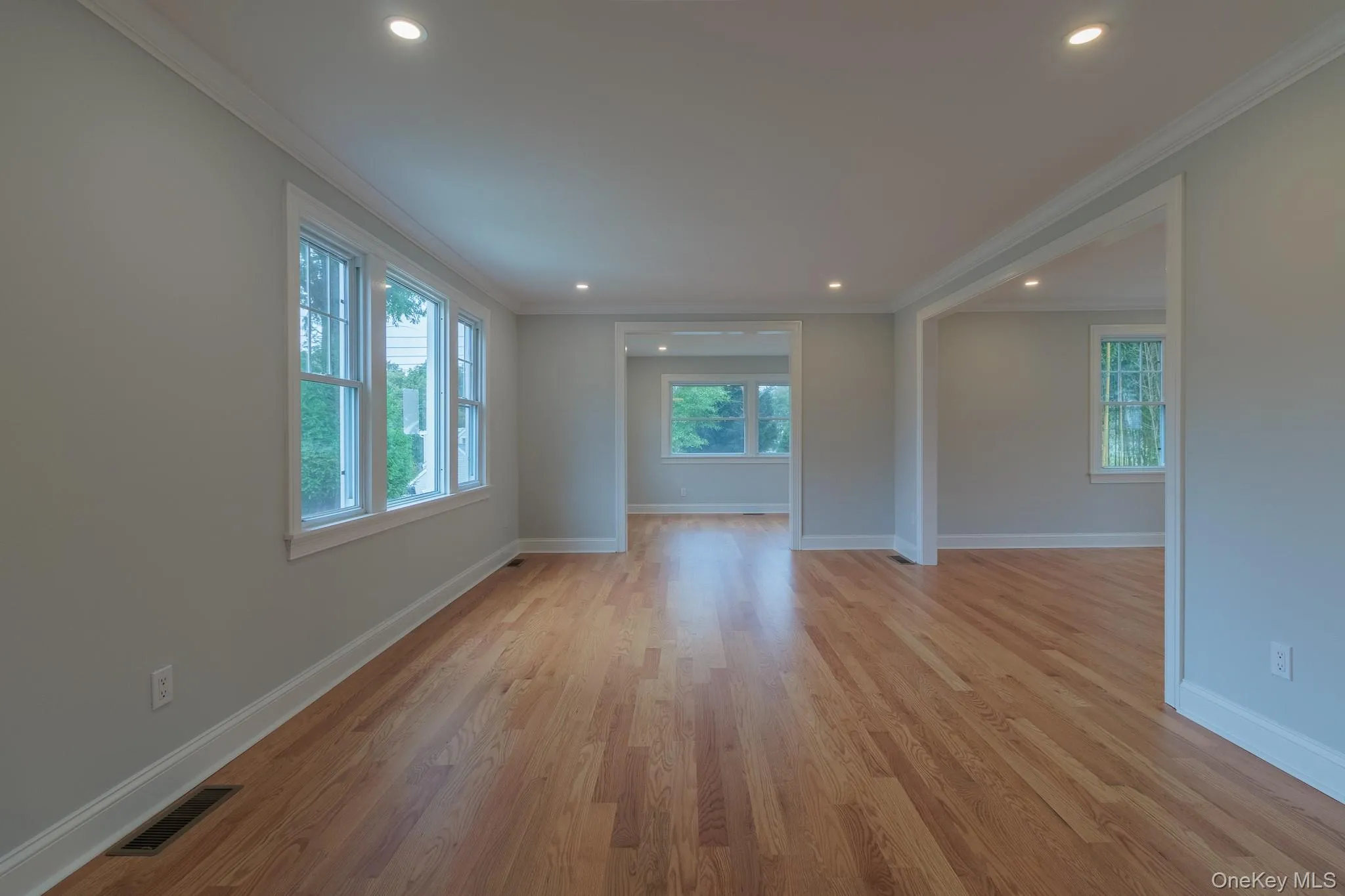 Spare room featuring crown molding, light wood-type flooring, and recessed lighting Spare room featuring crown molding, light wood-type flooring, and recessed lighting