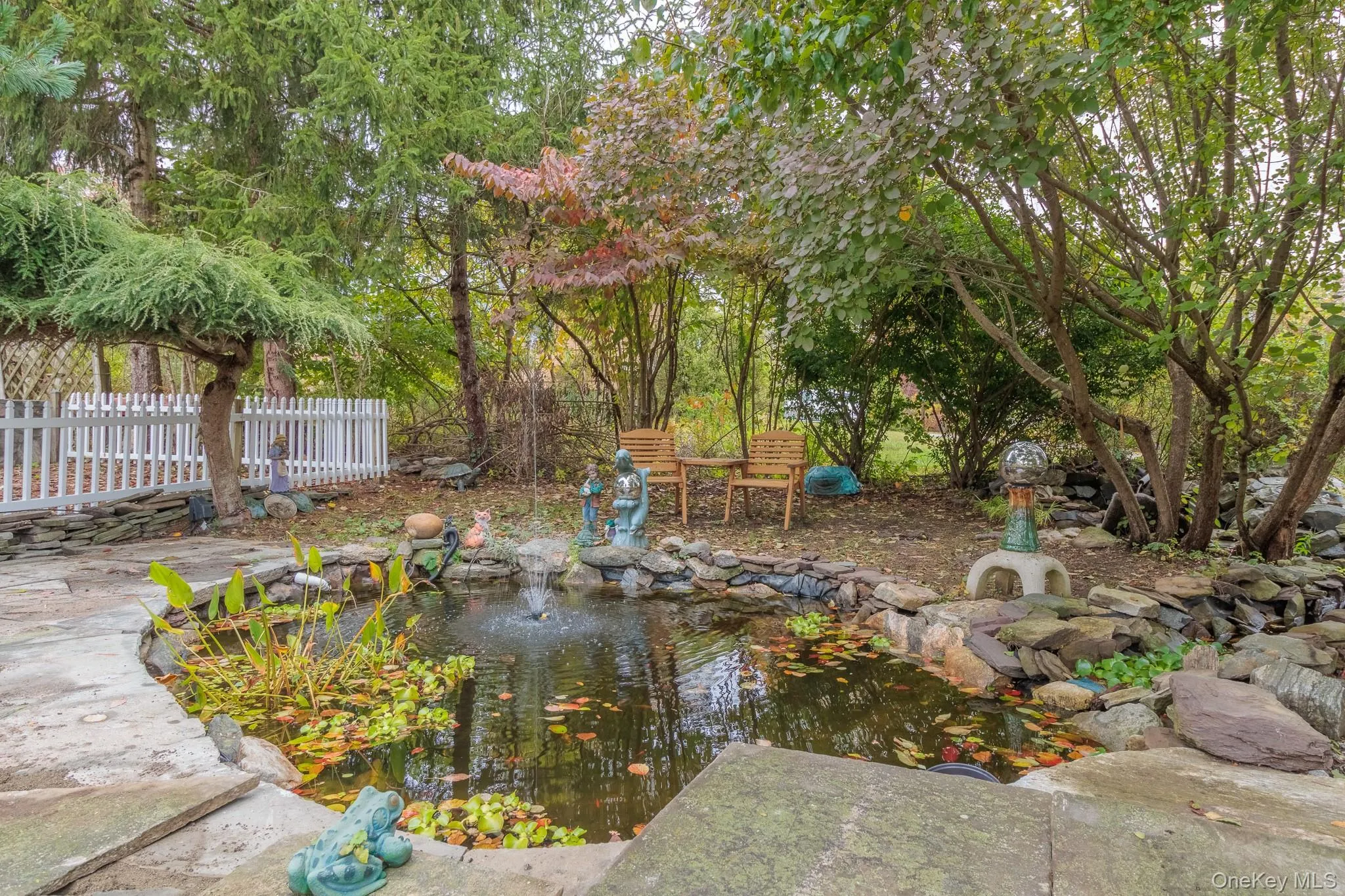 View of yard with a small pond and a patio area View of yard with a small pond and a patio area