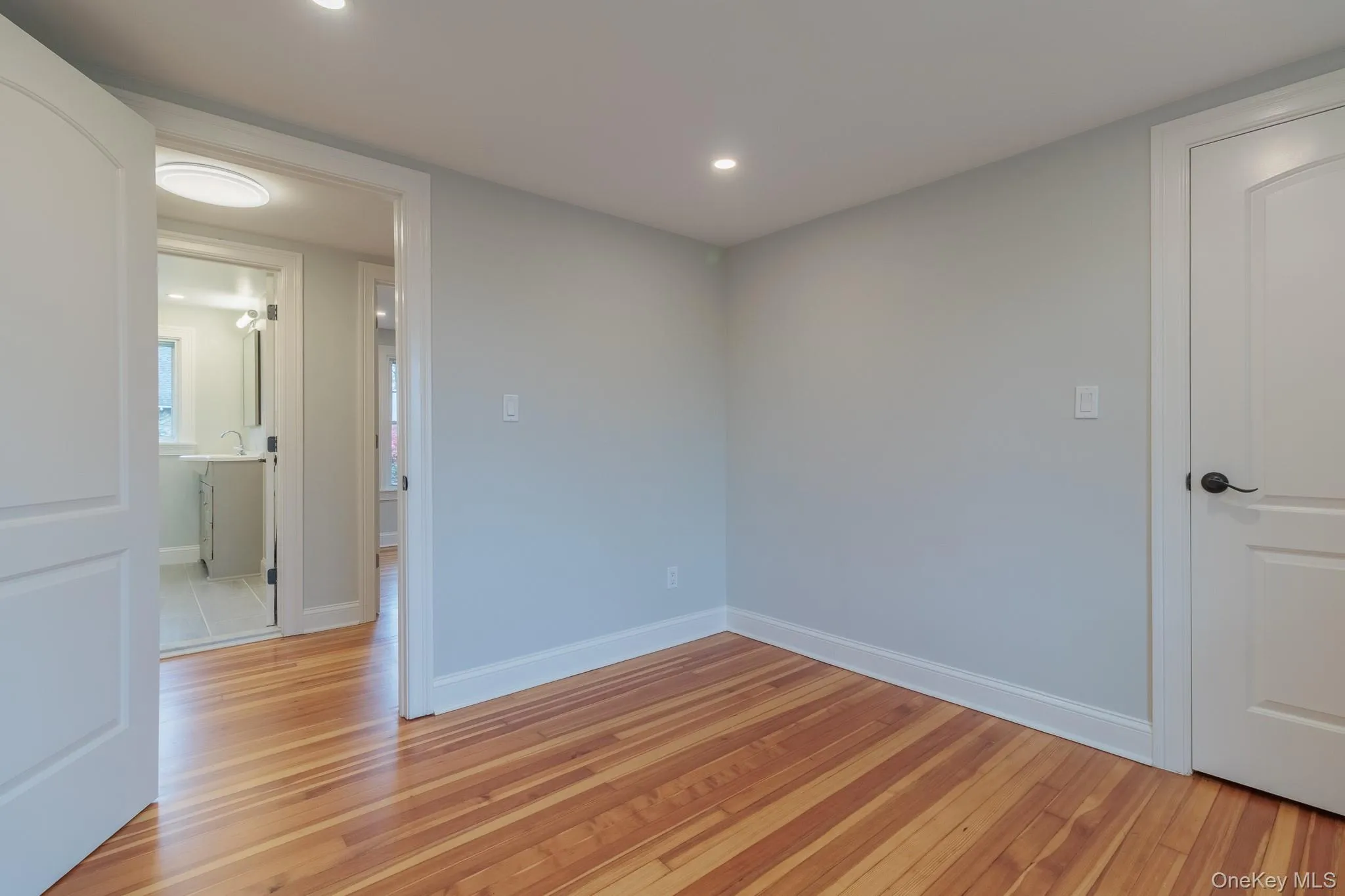 Unfurnished room with light wood-style floors and recessed lighting Unfurnished room with light wood-style floors and recessed lighting