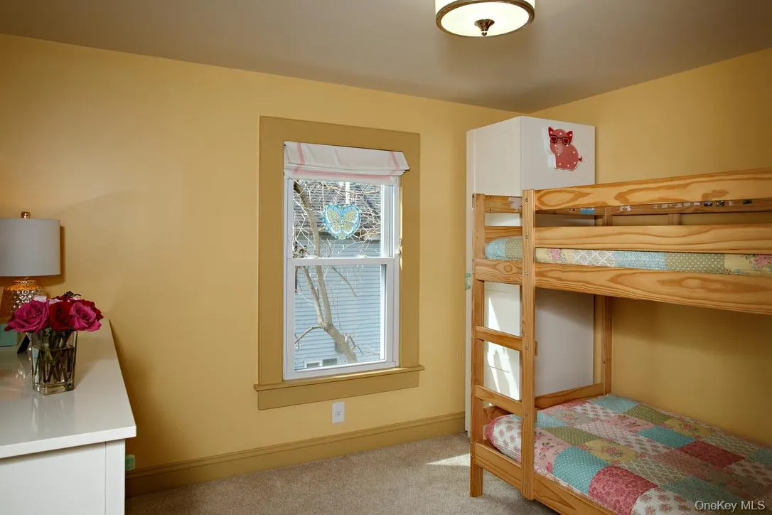 Bedroom with light colored carpet and baseboards Bedroom with light colored carpet and baseboards