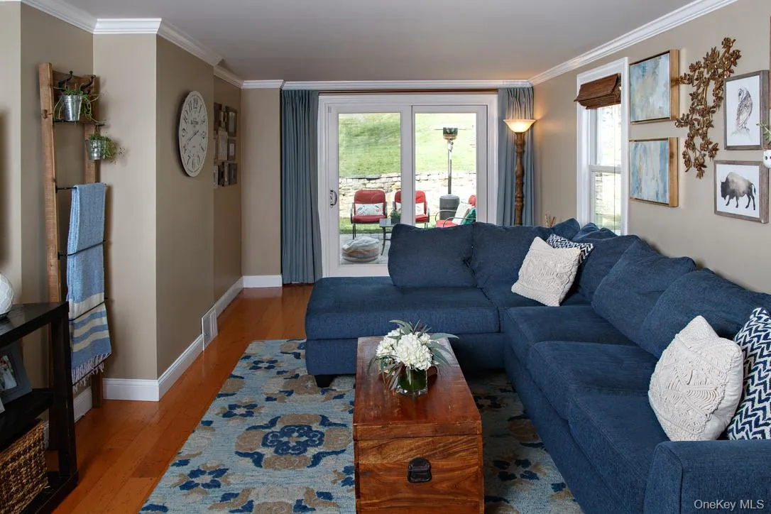 Living room with wood finished floors and crown molding Living room with wood finished floors and crown molding