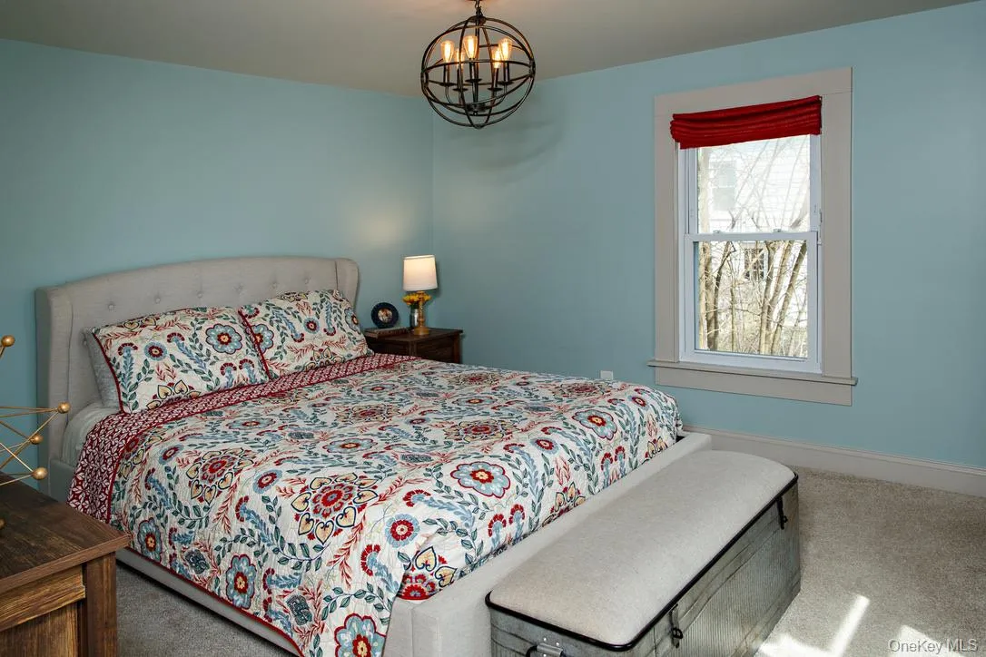 Bedroom with carpet and a chandelier Bedroom with carpet and a chandelier