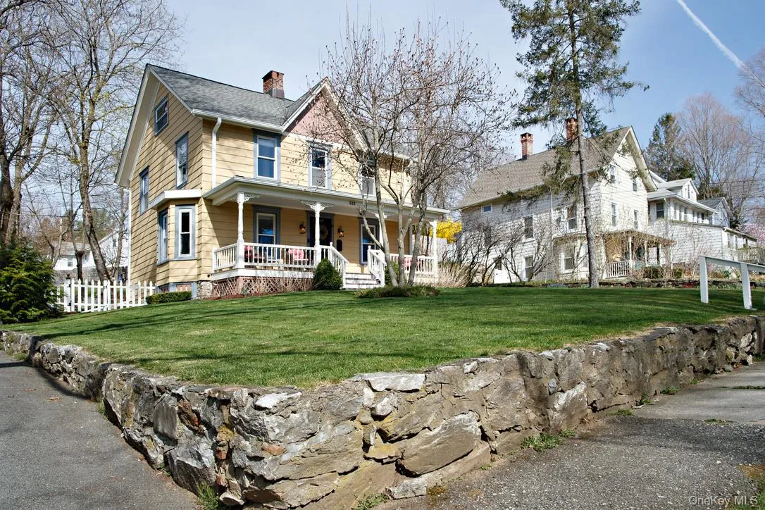 Farmhouse-style home with covered porch and a chimney Farmhouse-style home with covered porch and a chimney