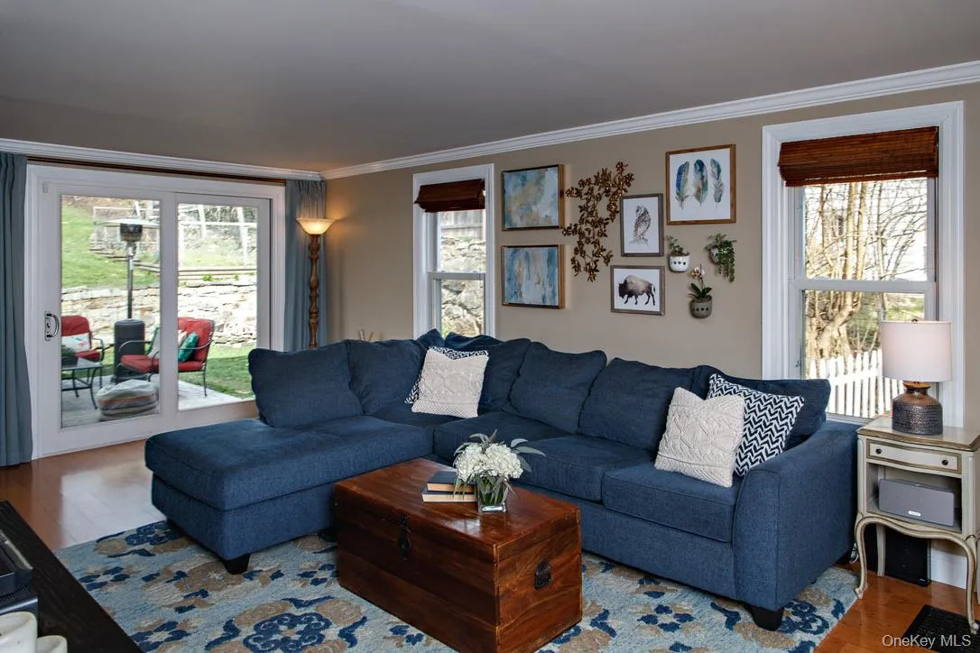 Living area with wood finished floors and ornamental molding Living area with wood finished floors and ornamental molding