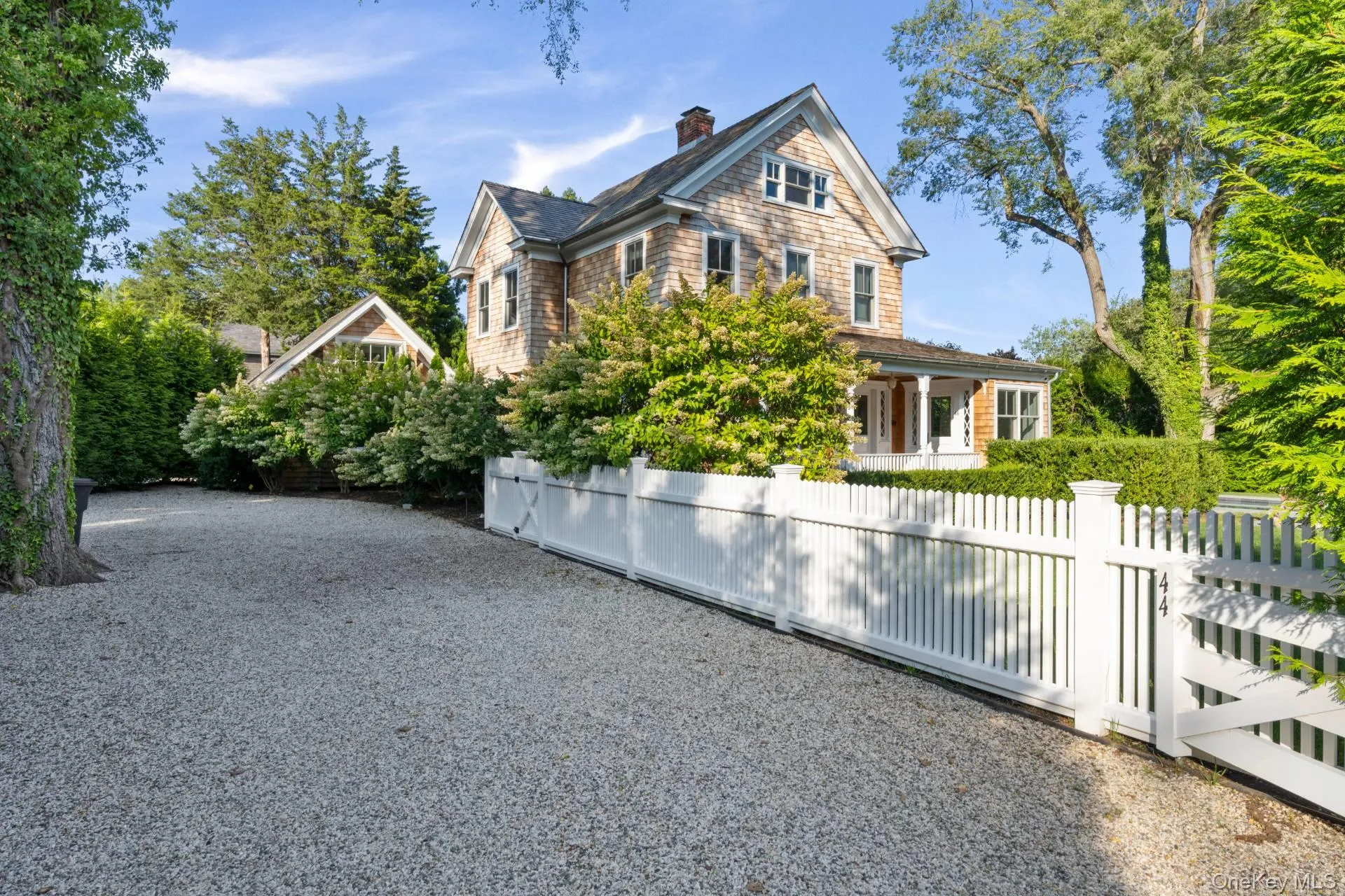 View of front of property with a chimney and gravel driveway View of front of property with a chimney and gravel driveway