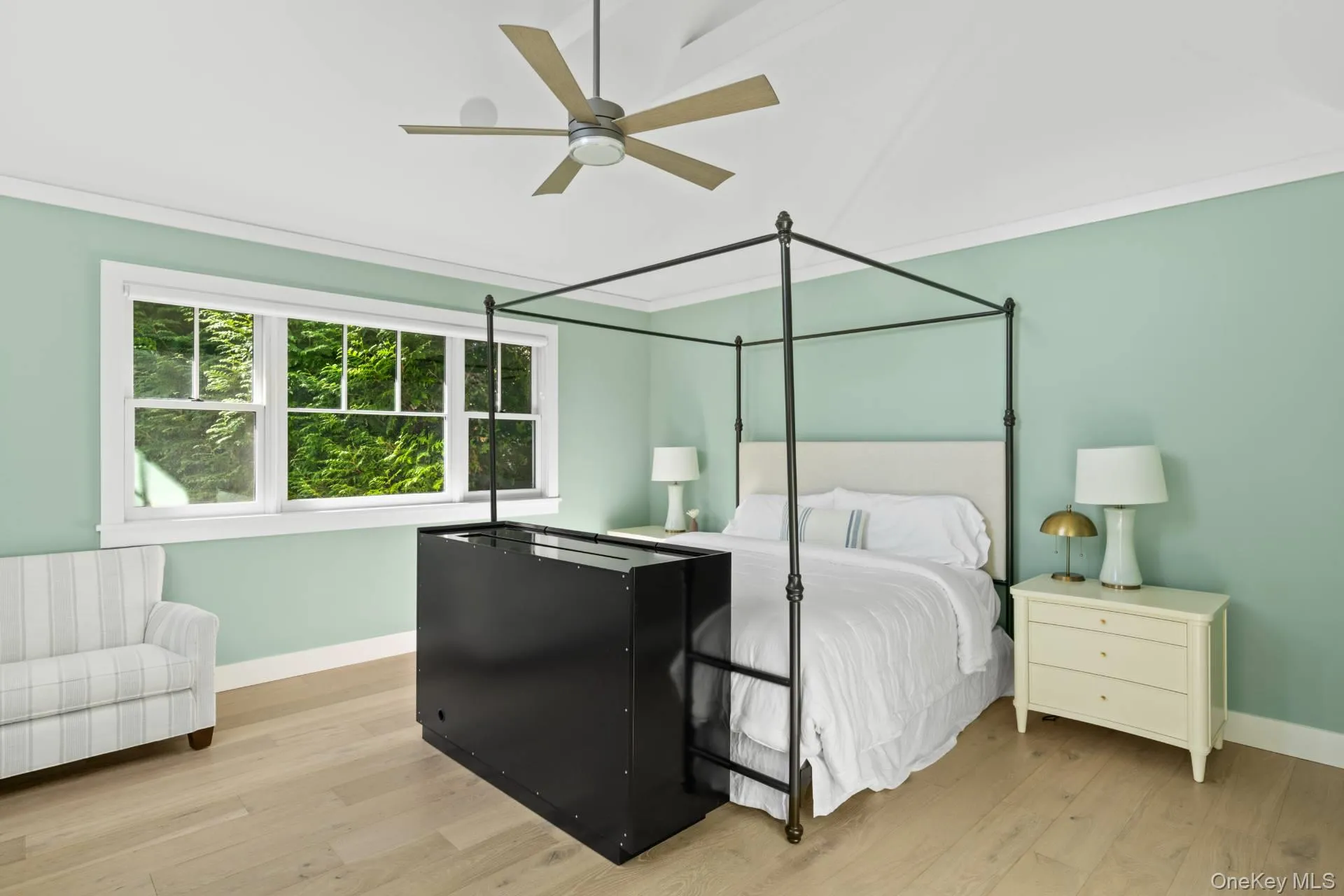 Bedroom featuring light wood-type flooring and ceiling fan Bedroom featuring light wood-type flooring and ceiling fan