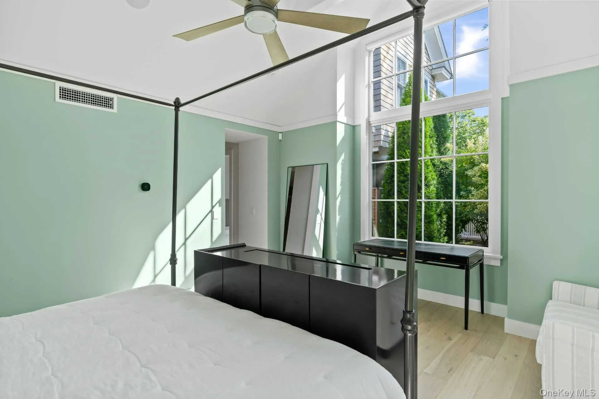 Bedroom featuring light wood-style flooring and ceiling fan Bedroom featuring light wood-style flooring and ceiling fan