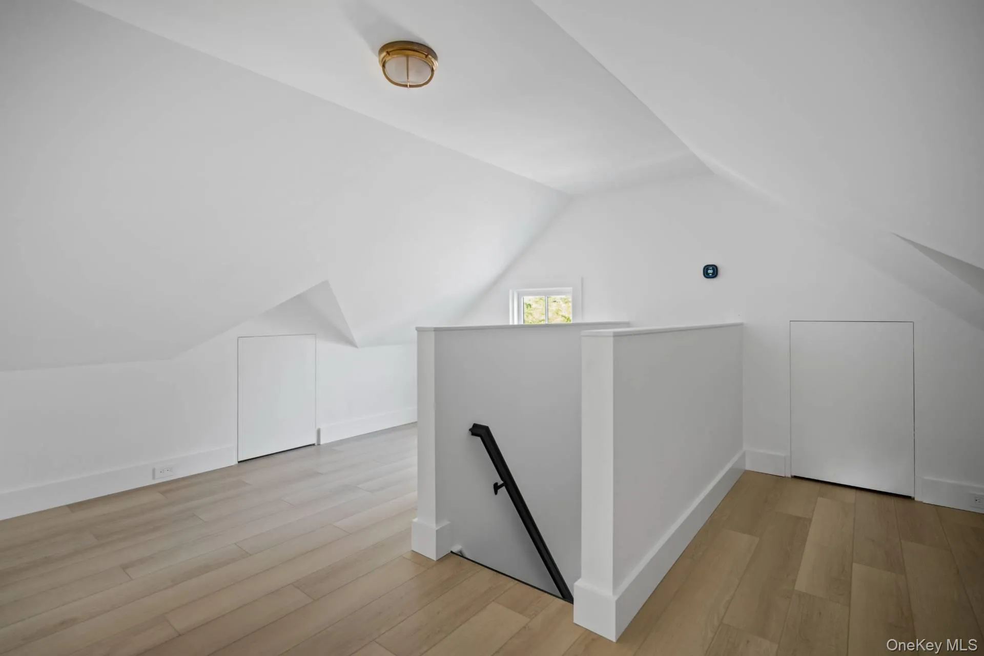 Additional living space with light wood finished floors and lofted ceiling Additional living space with light wood finished floors and lofted ceiling