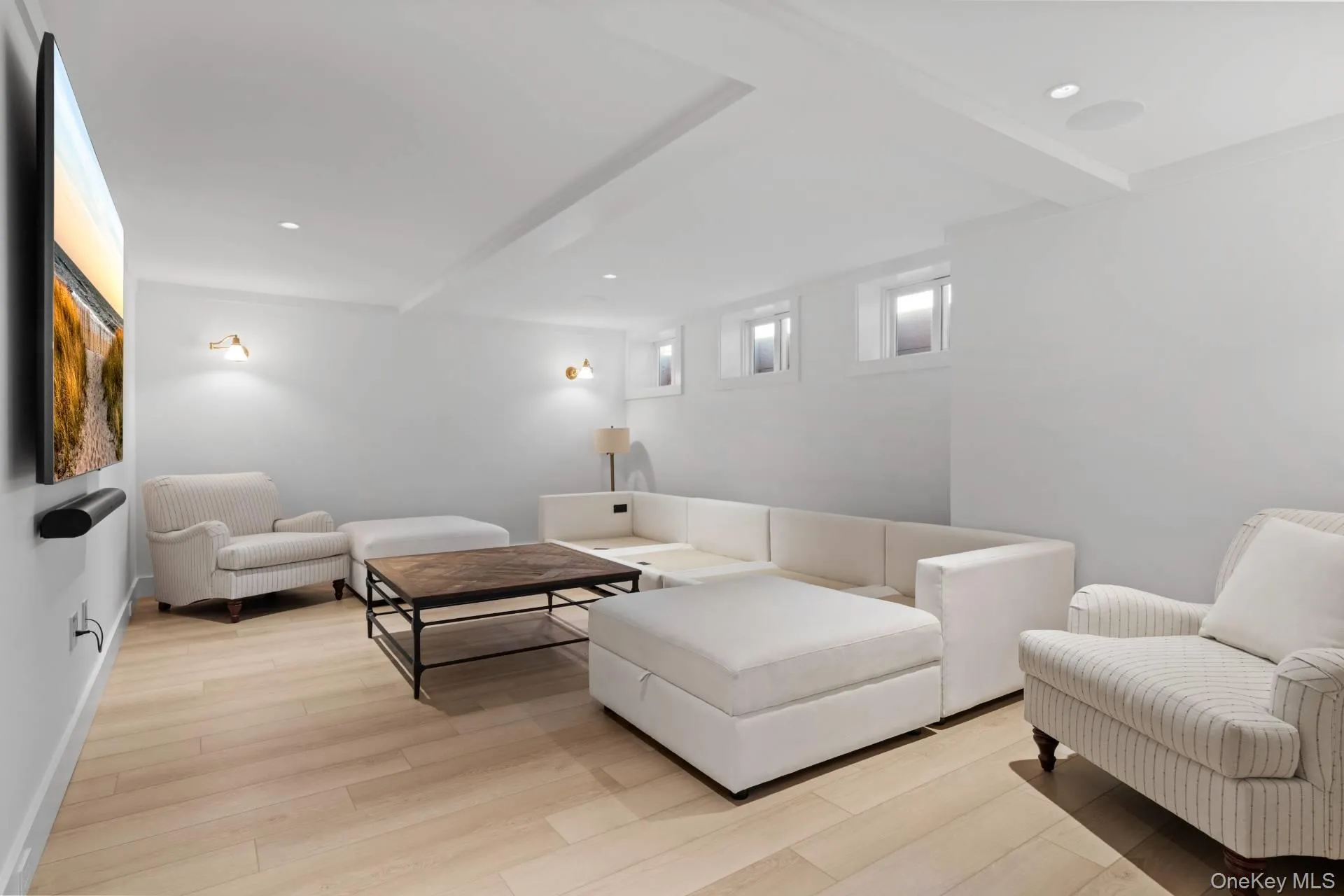 Living area with beamed ceiling, light wood finished floors, and recessed lighting Living area with beamed ceiling, light wood finished floors, and recessed lighting