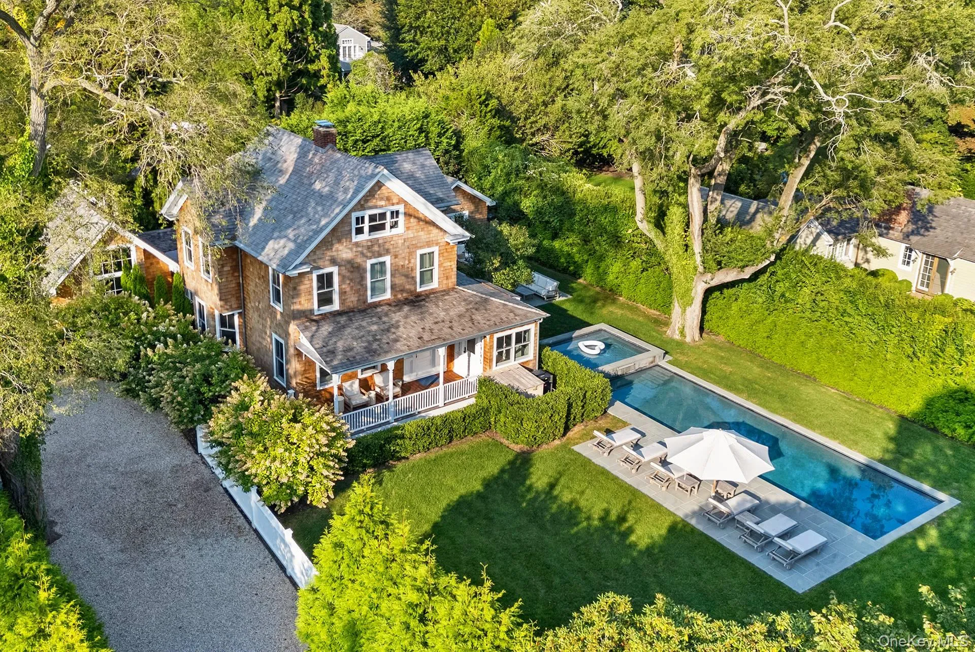 Aerial view of property and surrounding area featuring a pool area Aerial view of property and surrounding area featuring a pool area
