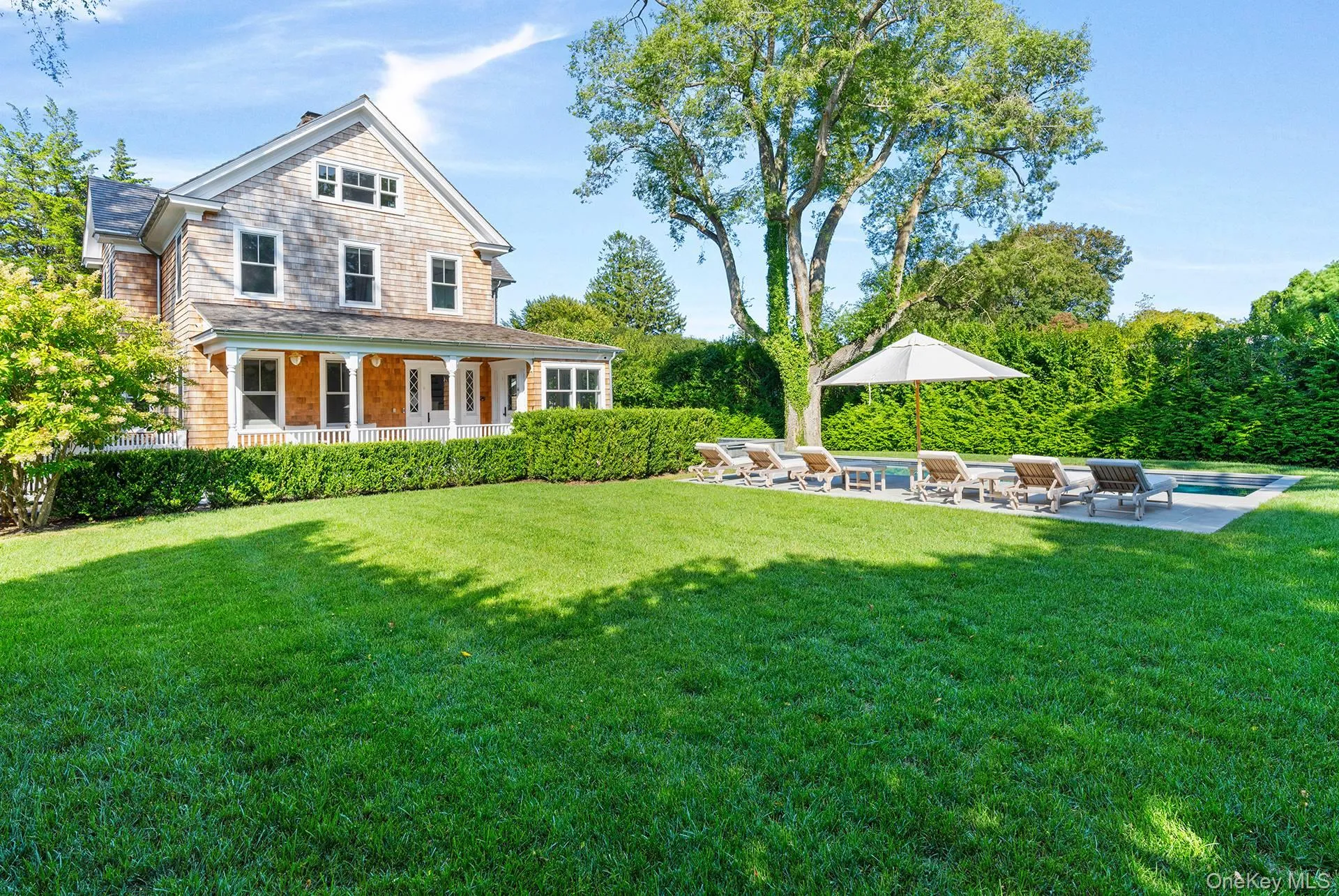View of green lawn with a patio, a swimming pool, and a porch View of green lawn with a patio, a swimming pool, and a porch