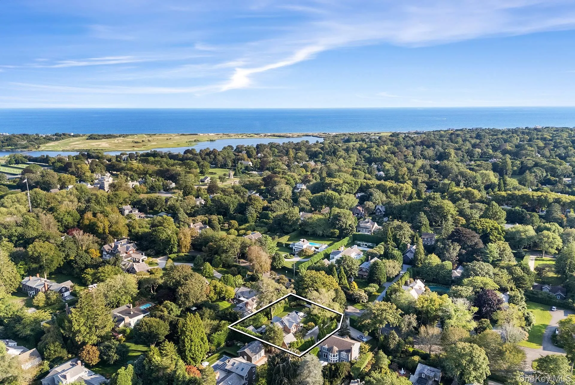 Aerial perspective of suburban area featuring property boundaries highlighted and a nearby body of water Aerial perspective of suburban area featuring property boundaries highlighted and a nearby body of water