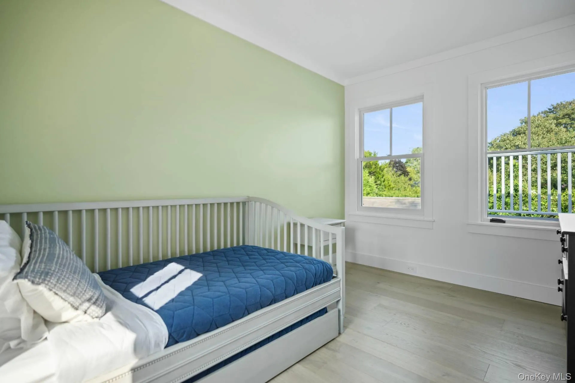 Bedroom with wood finished floors and baseboards Bedroom with wood finished floors and baseboards