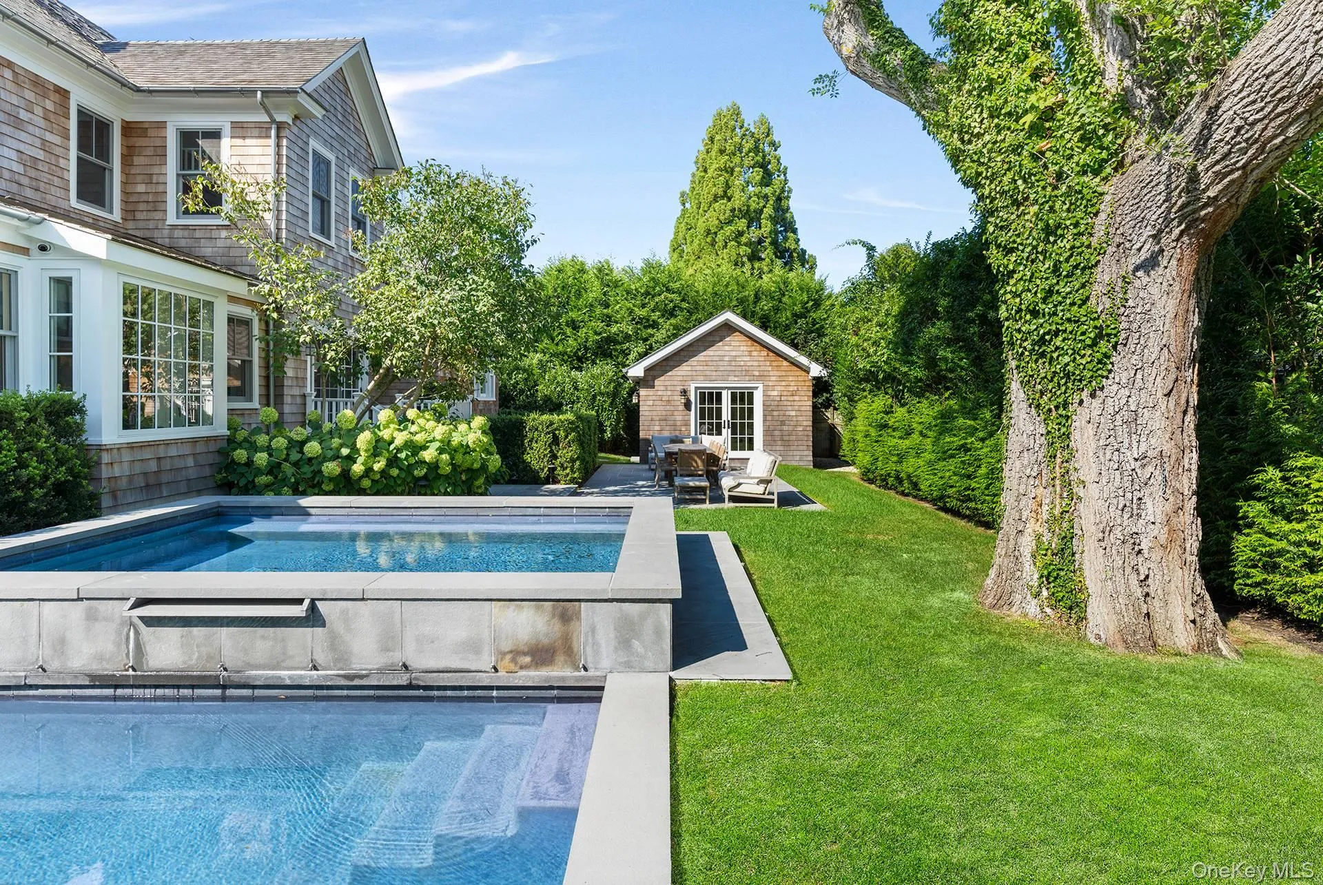 Outdoor pool with a yard, an outbuilding, a patio, and a storage structure Outdoor pool with a yard, an outbuilding, a patio, and a storage structure