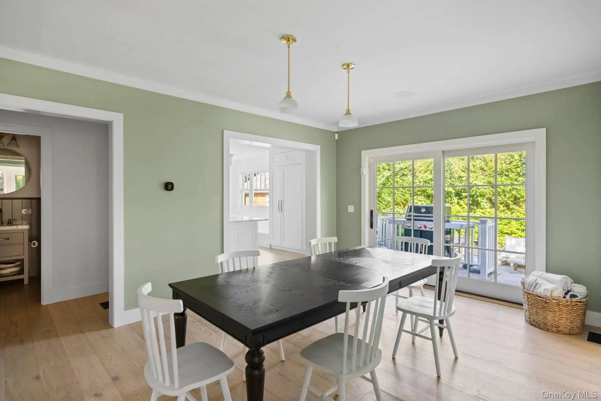 Dining room featuring light wood-style floors, plenty of natural light, and crown molding Dining room featuring light wood-style floors, plenty of natural light, and crown molding
