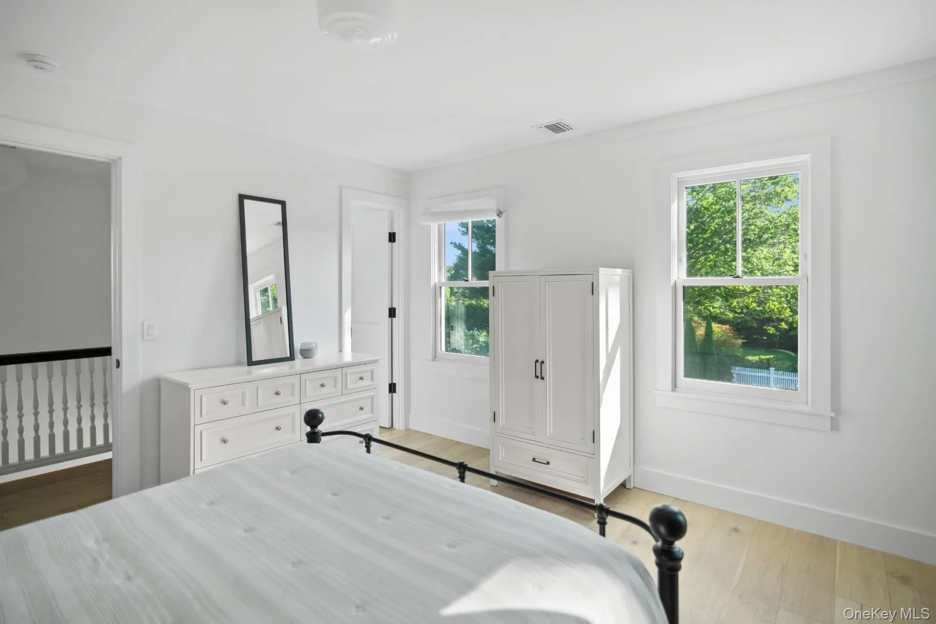 Bedroom with baseboards and light wood finished floors Bedroom with baseboards and light wood finished floors